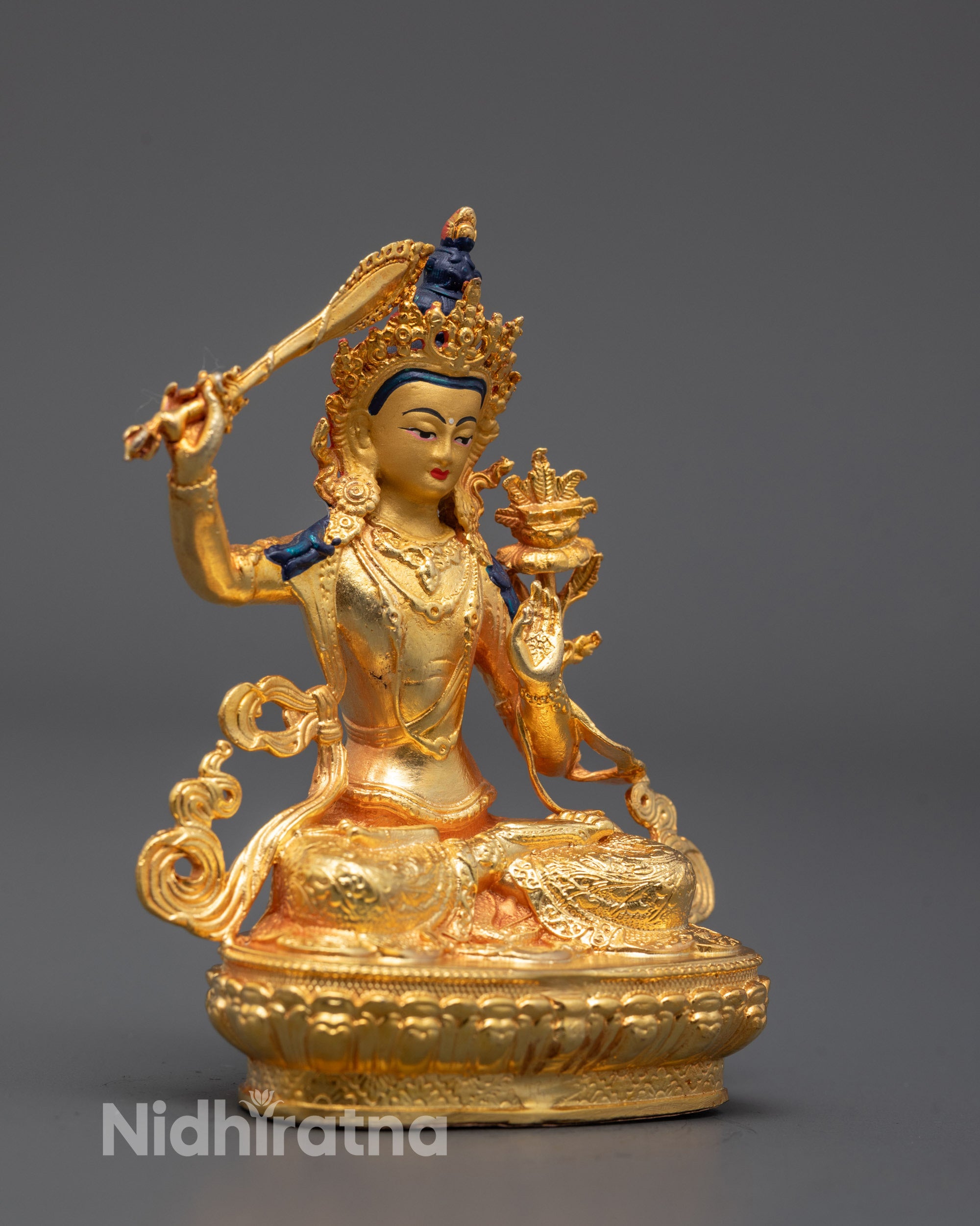 side view of bodhisattva manjushri idol with utpala flower and flowing lower garment