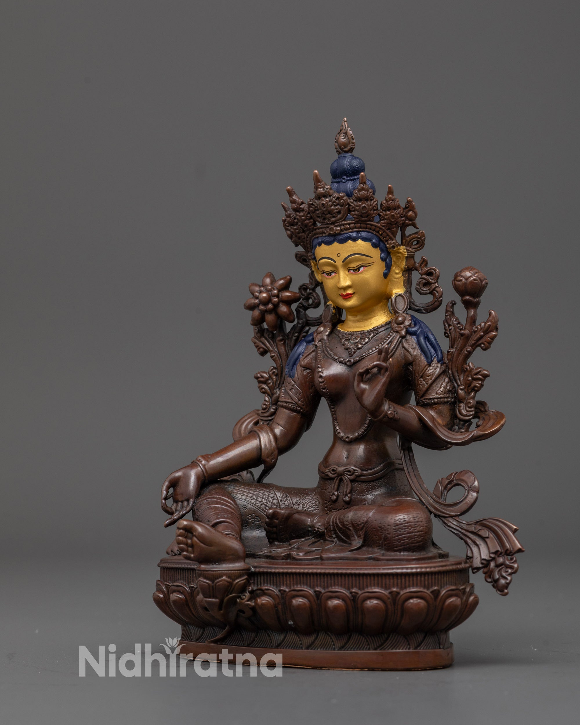 Side view of handcrafted Green Tara statue showing blessing mudra and lotus base detailing