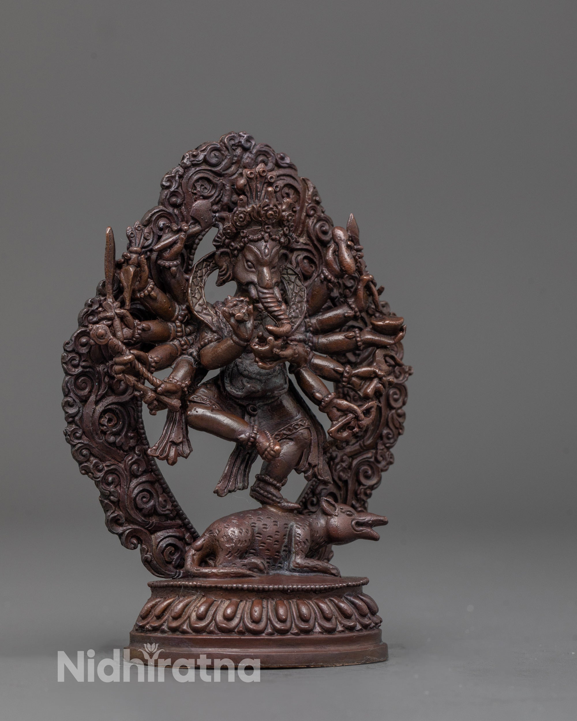 side view of oxidized Ganapati statue showing six arms and deep-tone antique finish