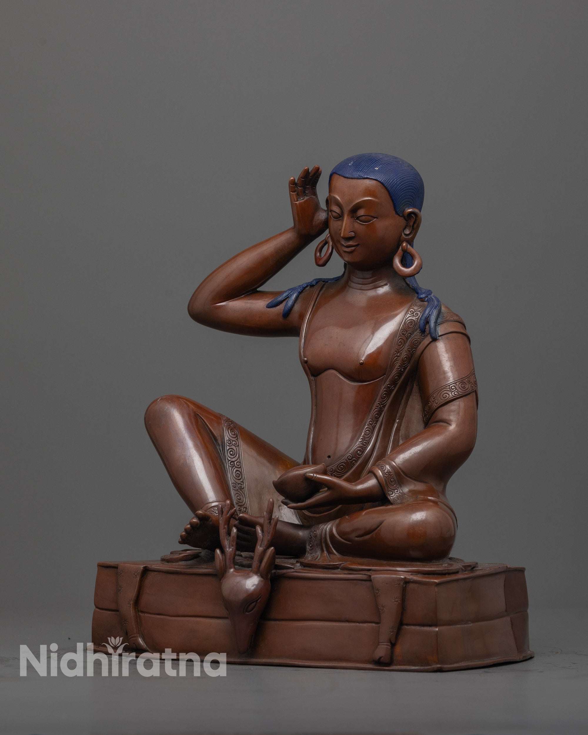 side view of oxidized copper Milarepa statue showing detailed robe folds and throne design