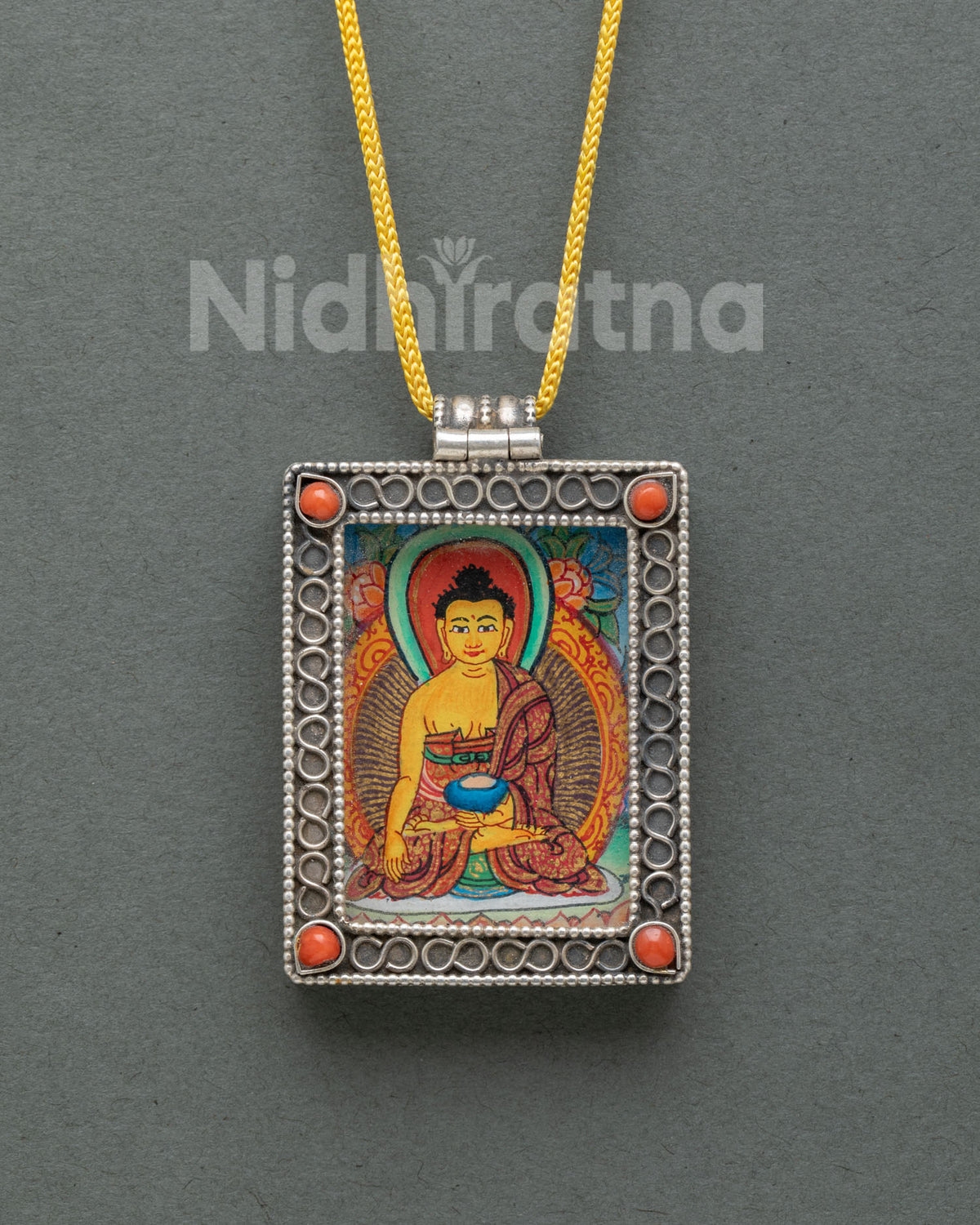 Silver Shakyamuni Buddha locket featuring an authentic miniature hand-painted Buddha thangka on cotton canvas with acrylic paints.