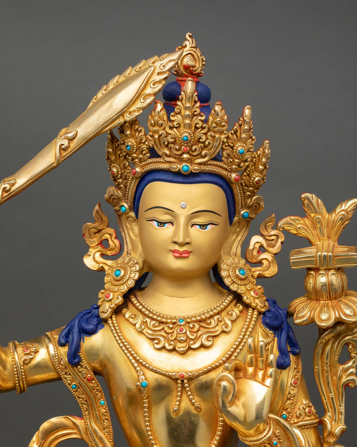 Simhada Manjushri close up gold painted face detail lost wax copper Buddhist sculpture Nepal