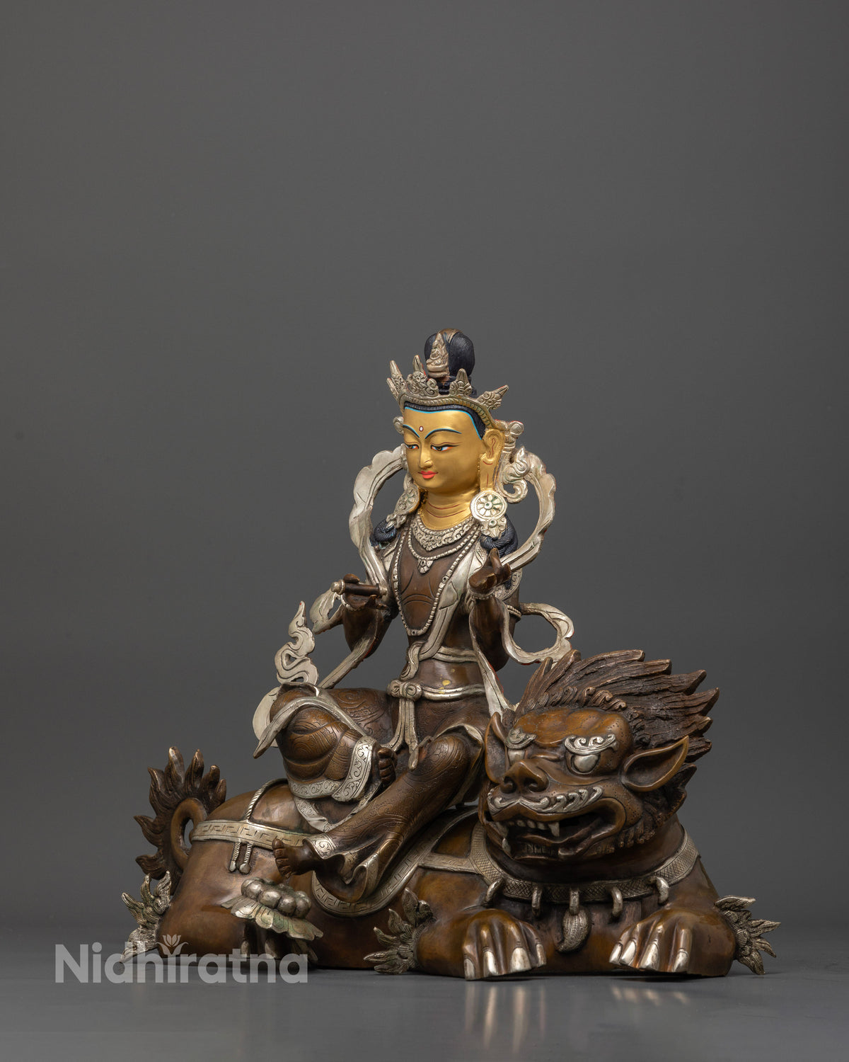 Simhanada chenrezig statue with hand carved floral silk garment and silver plated robe.