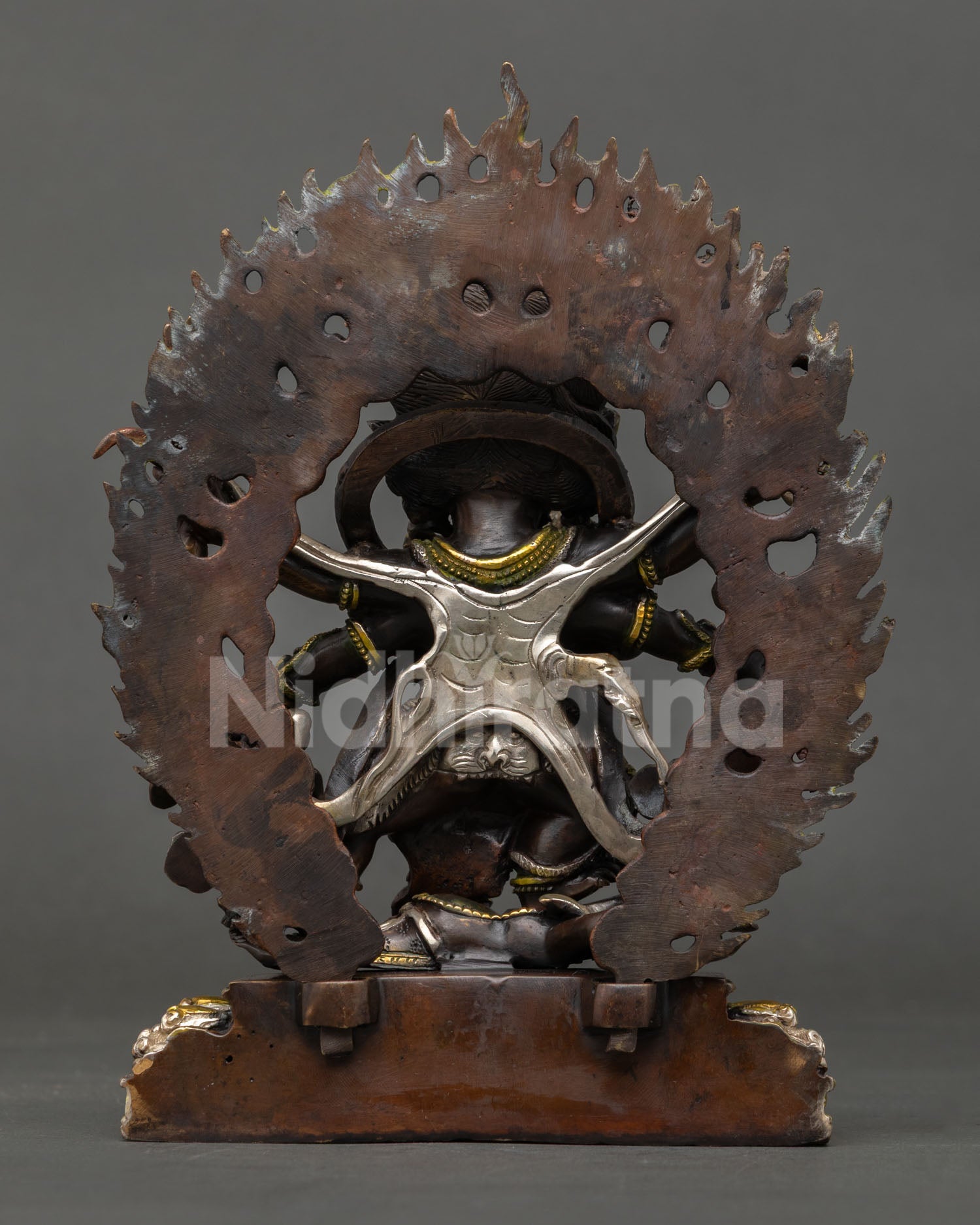 Six-armed Mahakala statue back view, oxidized copper Himalayan Buddhist deity Nepal