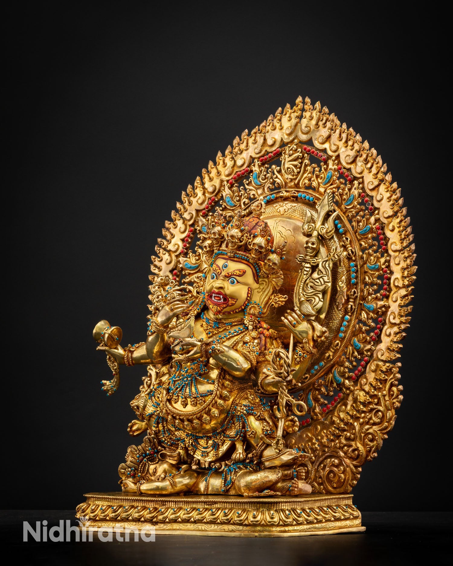 Six Armed Mahakala statue right side view alidha posture copper sculpture with gold gilding ritual implements Tibetan Buddhist art Nepal
