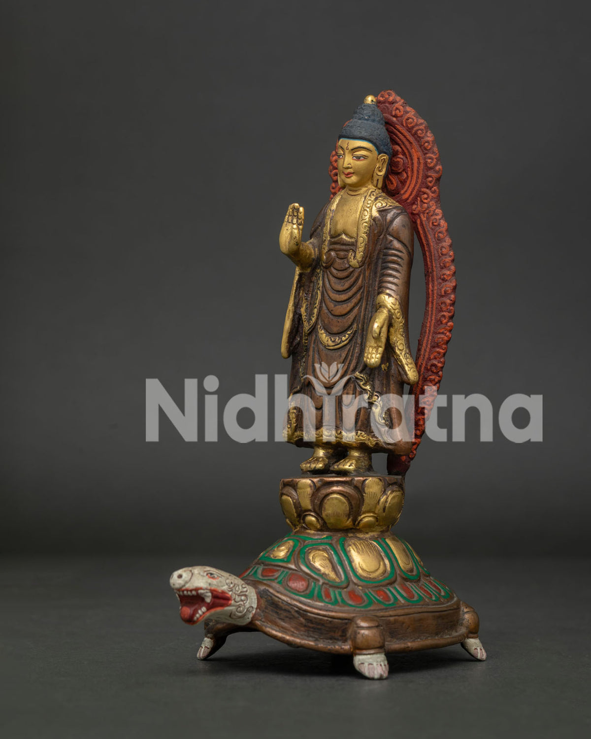 Standing Buddha statue detailed view gold painted face and oxidized antique finish.