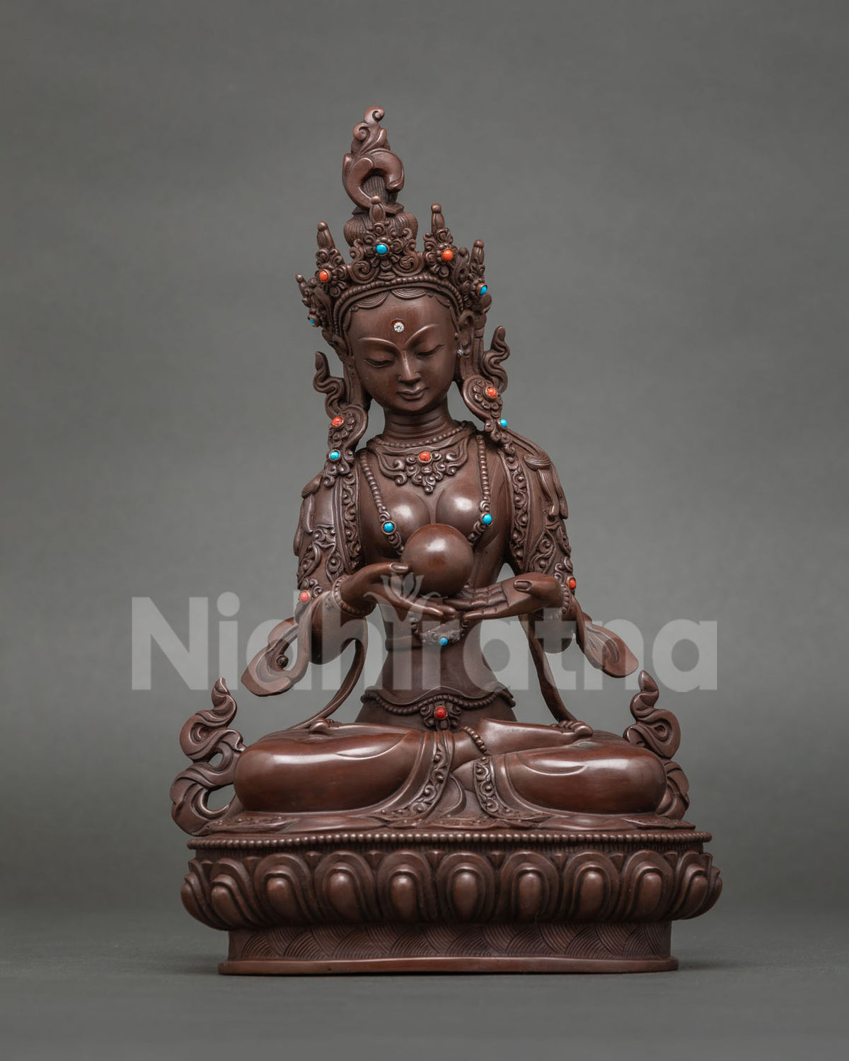 Sukhasadhani Tara statue holding an orb, bringer of ease and joy, oxidized copper
