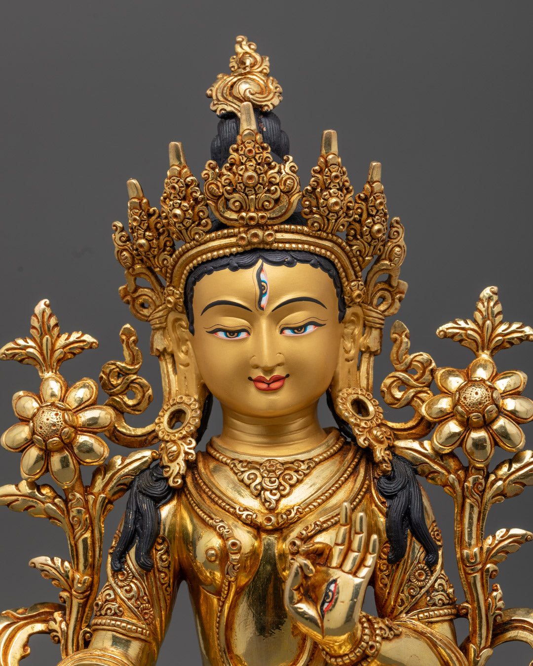 the White Tara Statue's serene face and intricate gold-plated details, showcasing fine Himalayan craftsmanship and sacred spiritual elegance