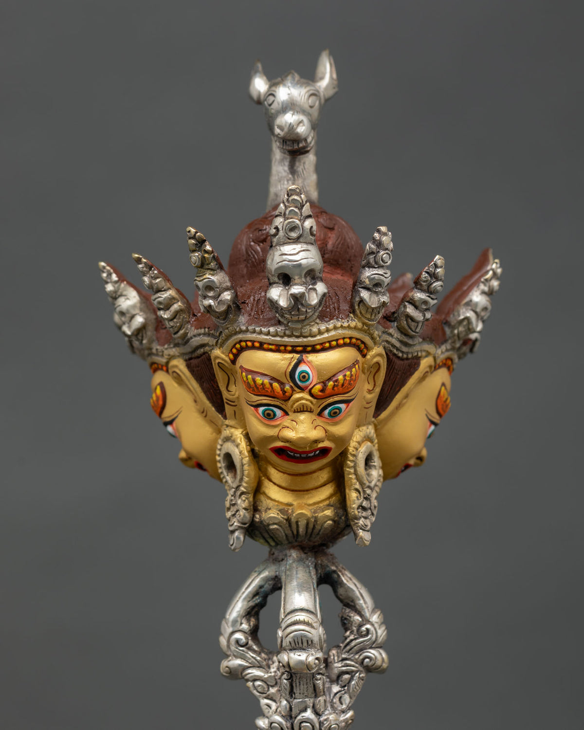 Three headed Vajrakilaya Phurba with gold painted faces and ornate details