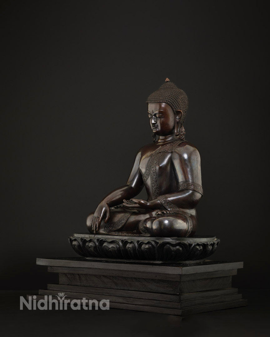 Three-quarter view of Shakyamuni Buddha statue in bhumisparsa mudra, cast in solid copper, Nepal