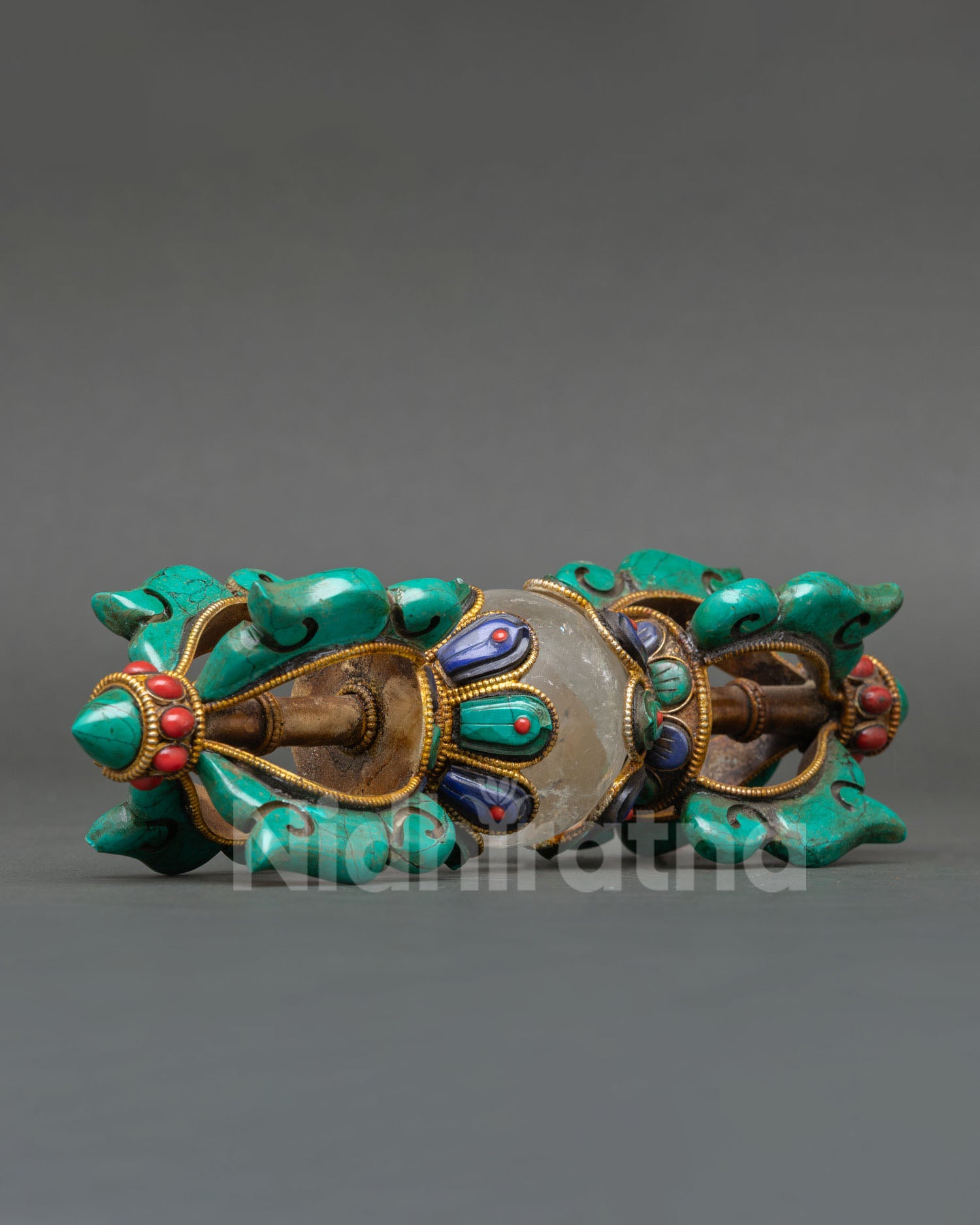 tibetan buddhist vajra with ornate copper body and semi-precious stone inlay