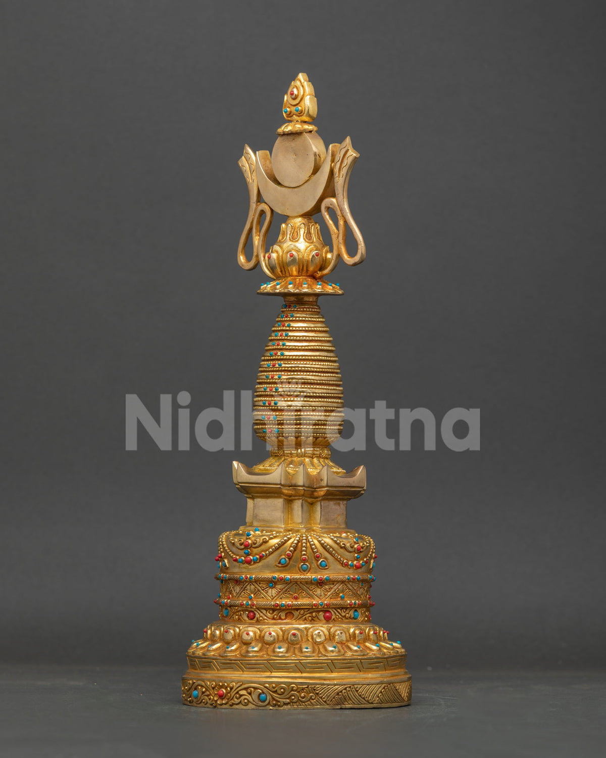 Tibetan Chorten featuring tiered spire sun crescent moon and flaming jewel