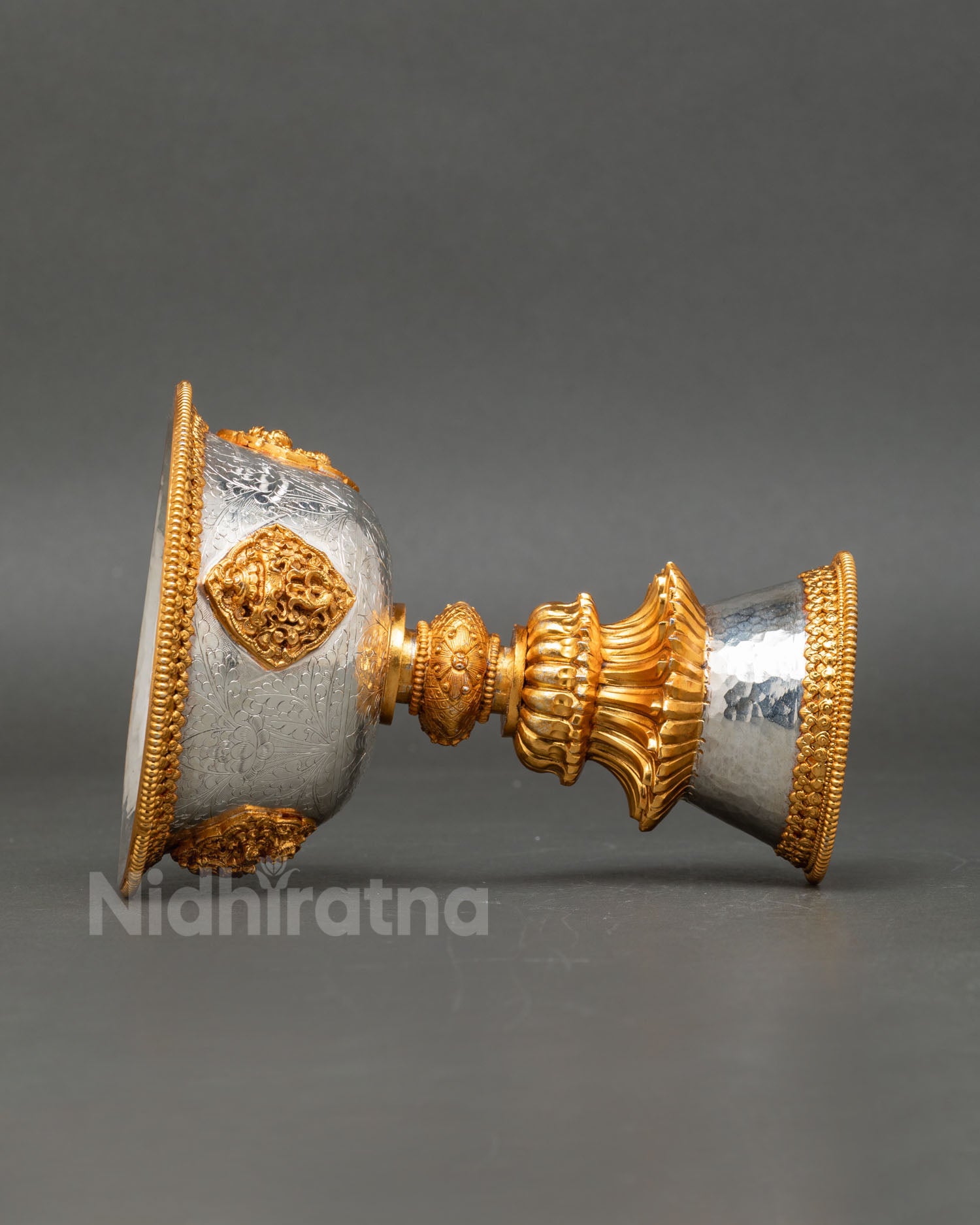 Tibetan ritual butter lamp displaying traditional Newari handcrafted metalwork with symbolic engravings for meditation and temple ceremony use