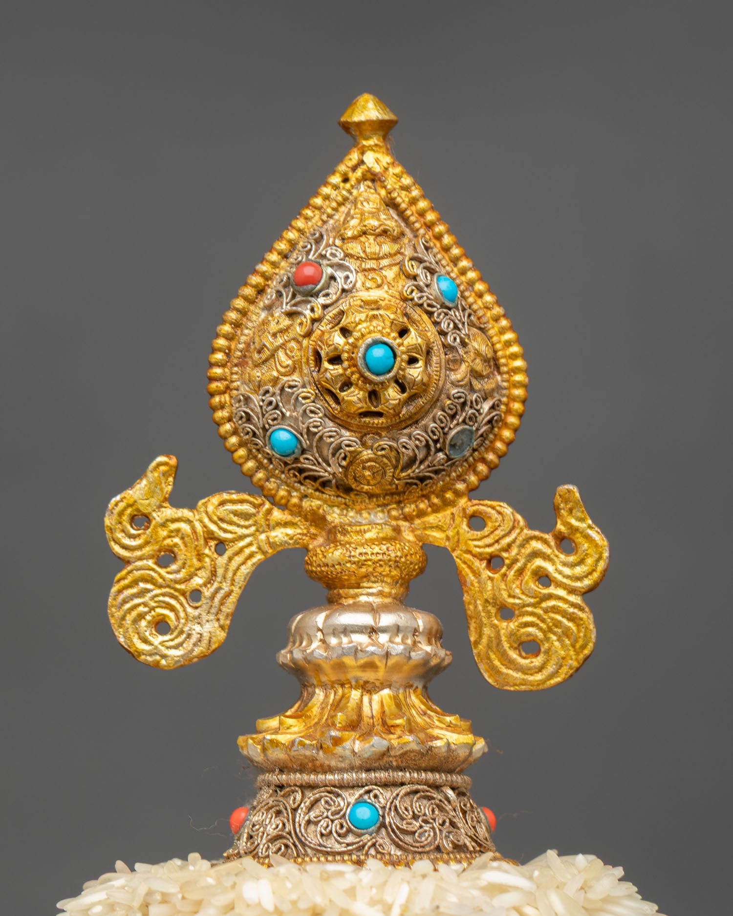 traditional tibetan mandala offering with dharma chakra finial and gemstones