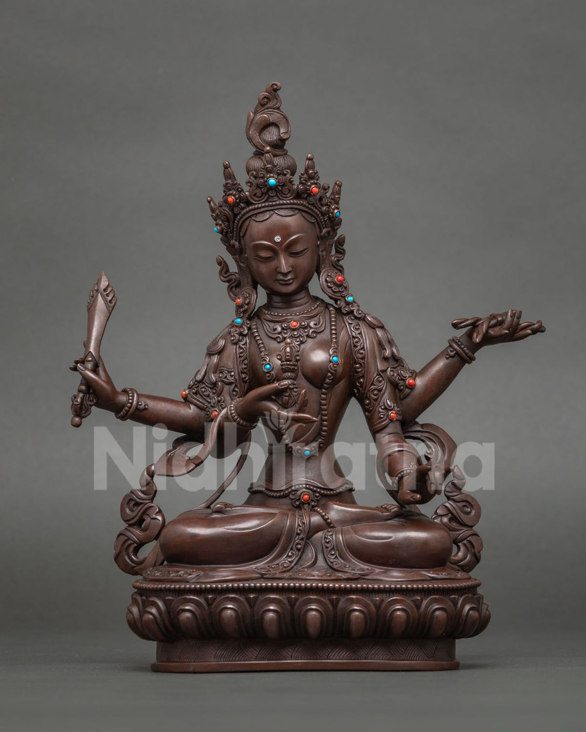 Trailokyavijaya Tara statue holding a vajra, victor over three worlds, oxidized copper
