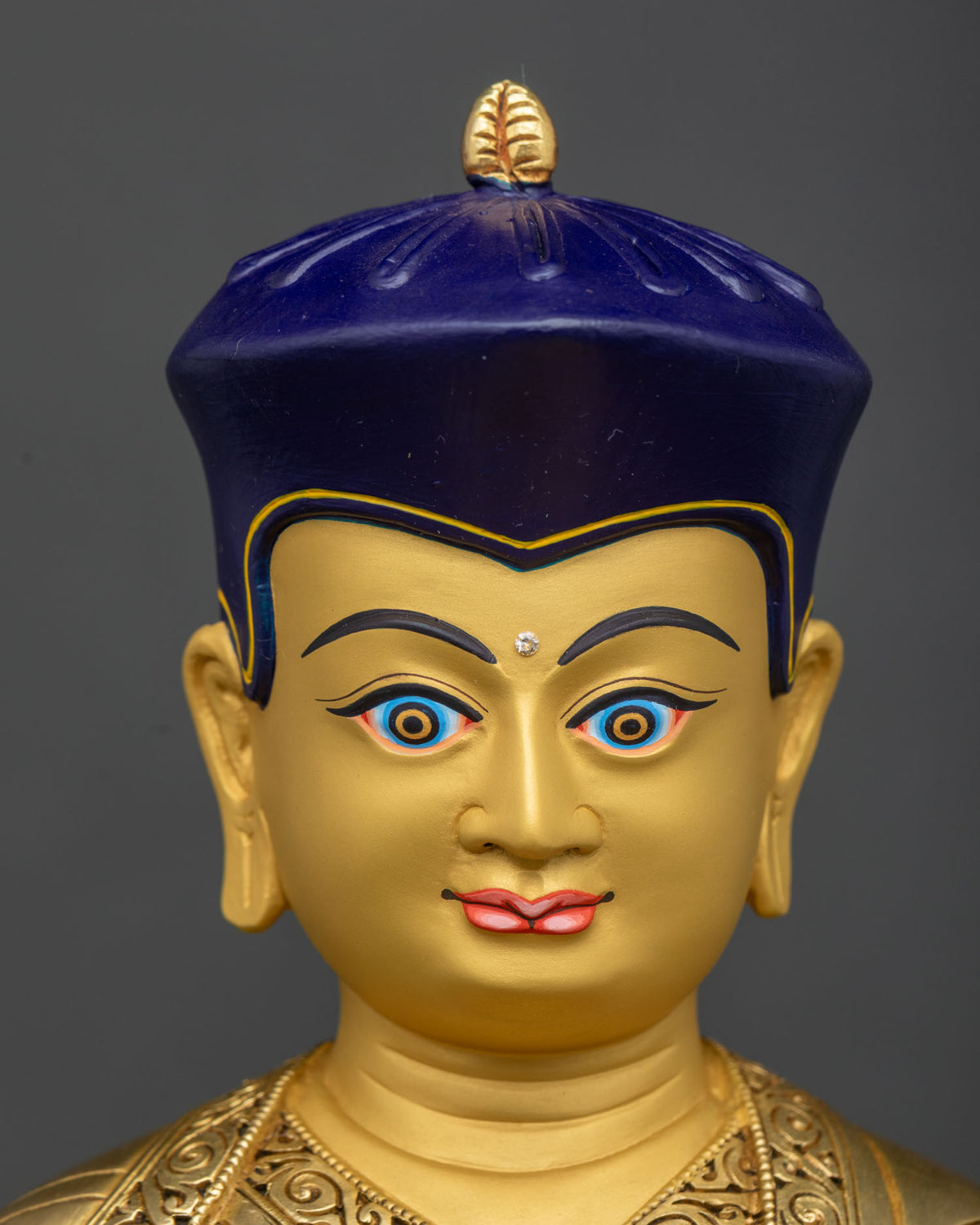 Tsangpa Gyare Statue face close-up, serene gold-painted expression detail