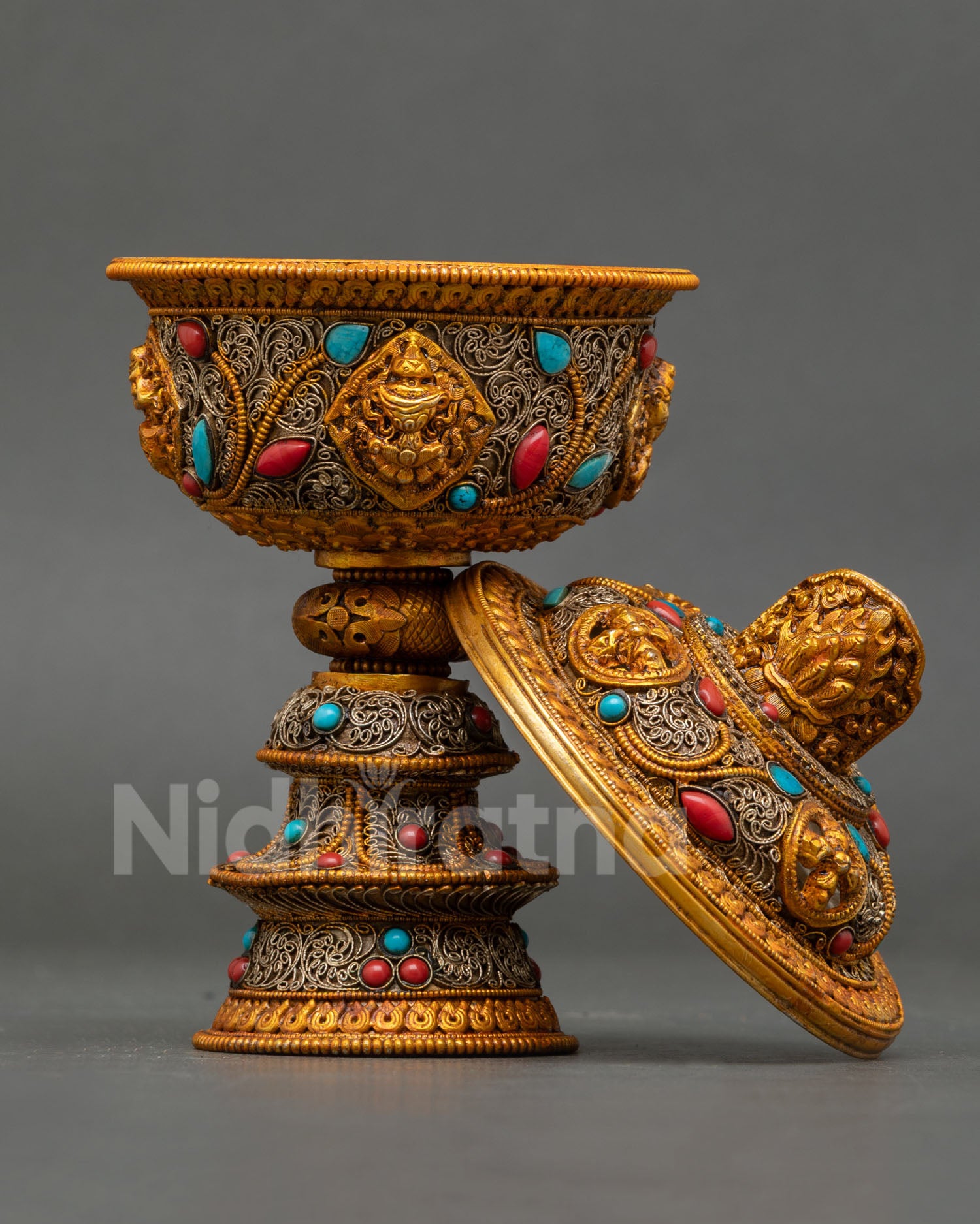Turquoise and coral semi-precious stones set in marquise and cabochon cuts on Tibetan ritual butter lamp body
