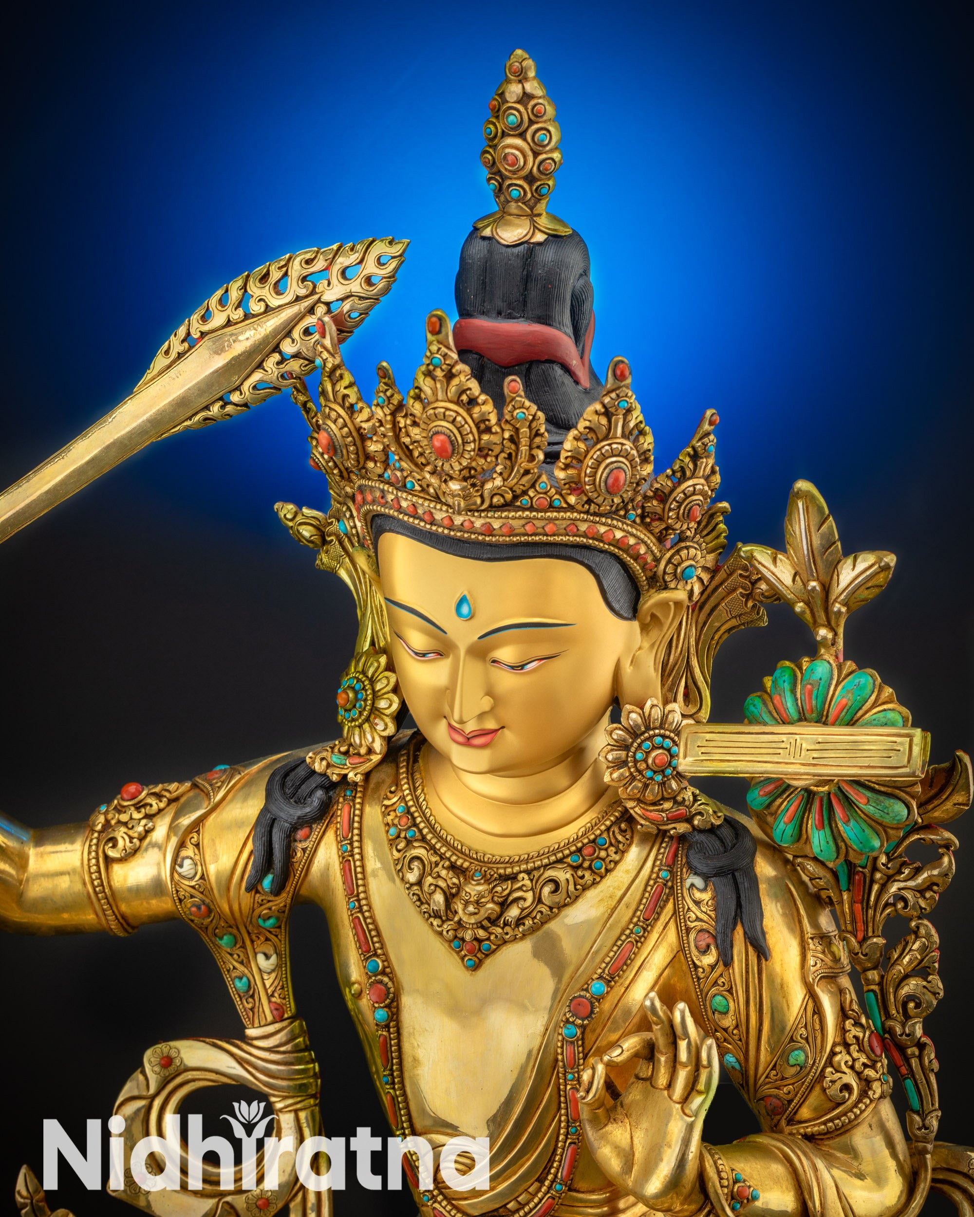 upper close up Manjushri statue serene face gold-gilded copper alloy artwork