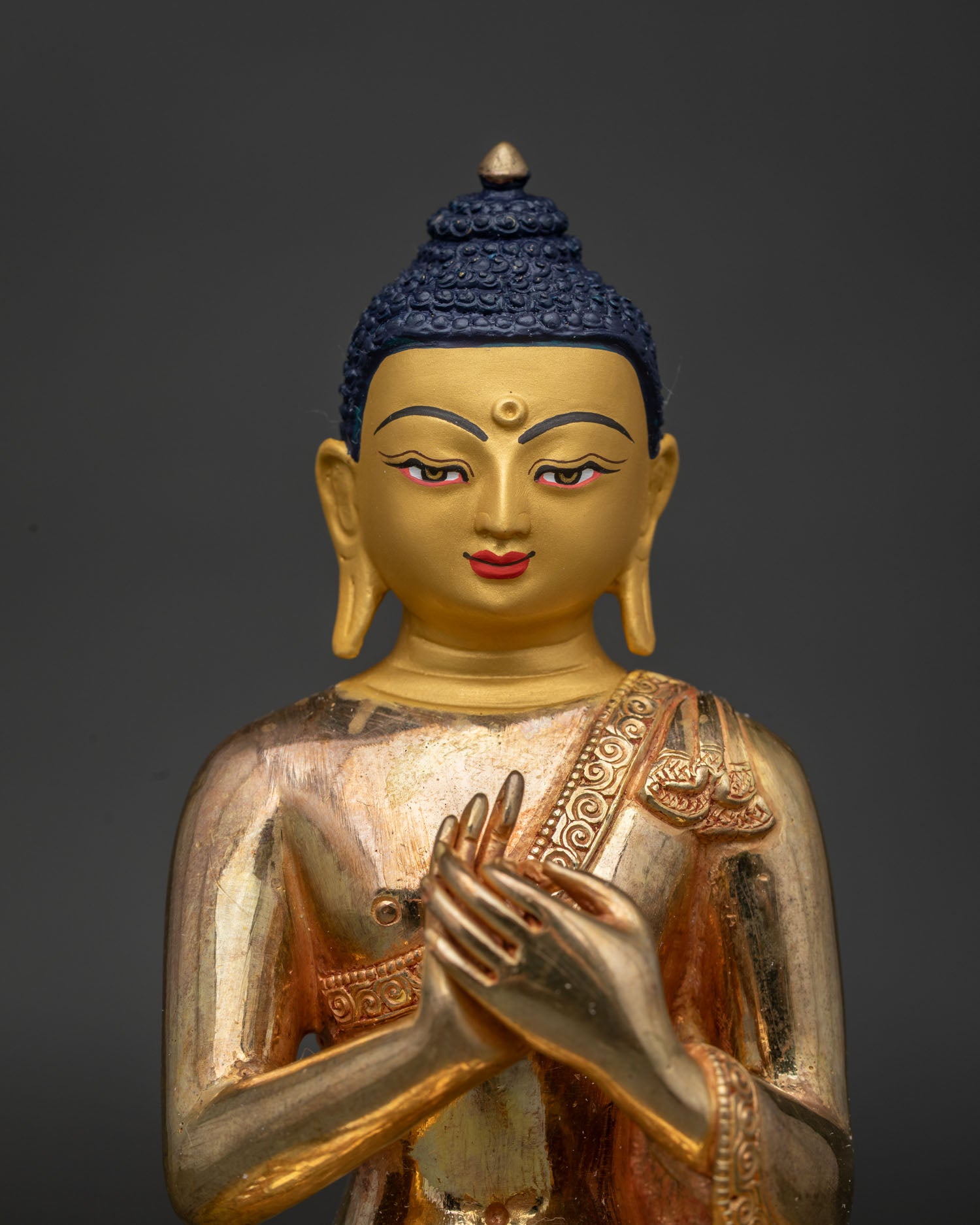 Vairocana Buddha Statue Close Up 24K Gold Painted Face and Serene Expression.