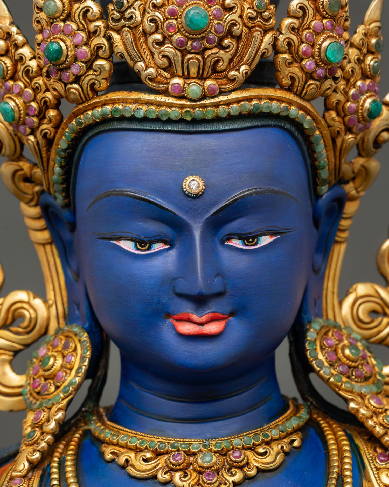 Vajradhara Buddha face close up with serene expression and jeweled crown details