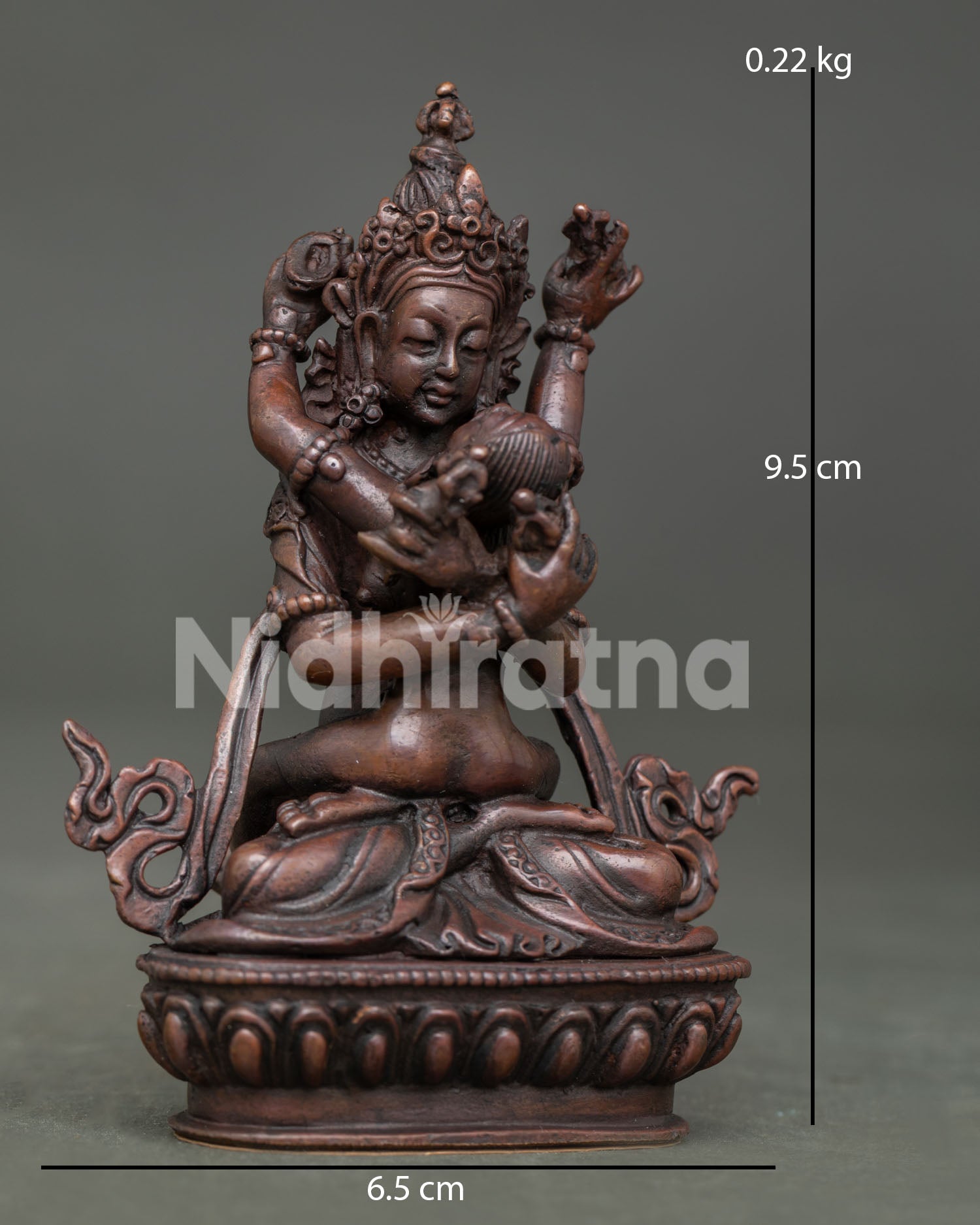 Vajradhara with consort side view with vajra bell and kapala.