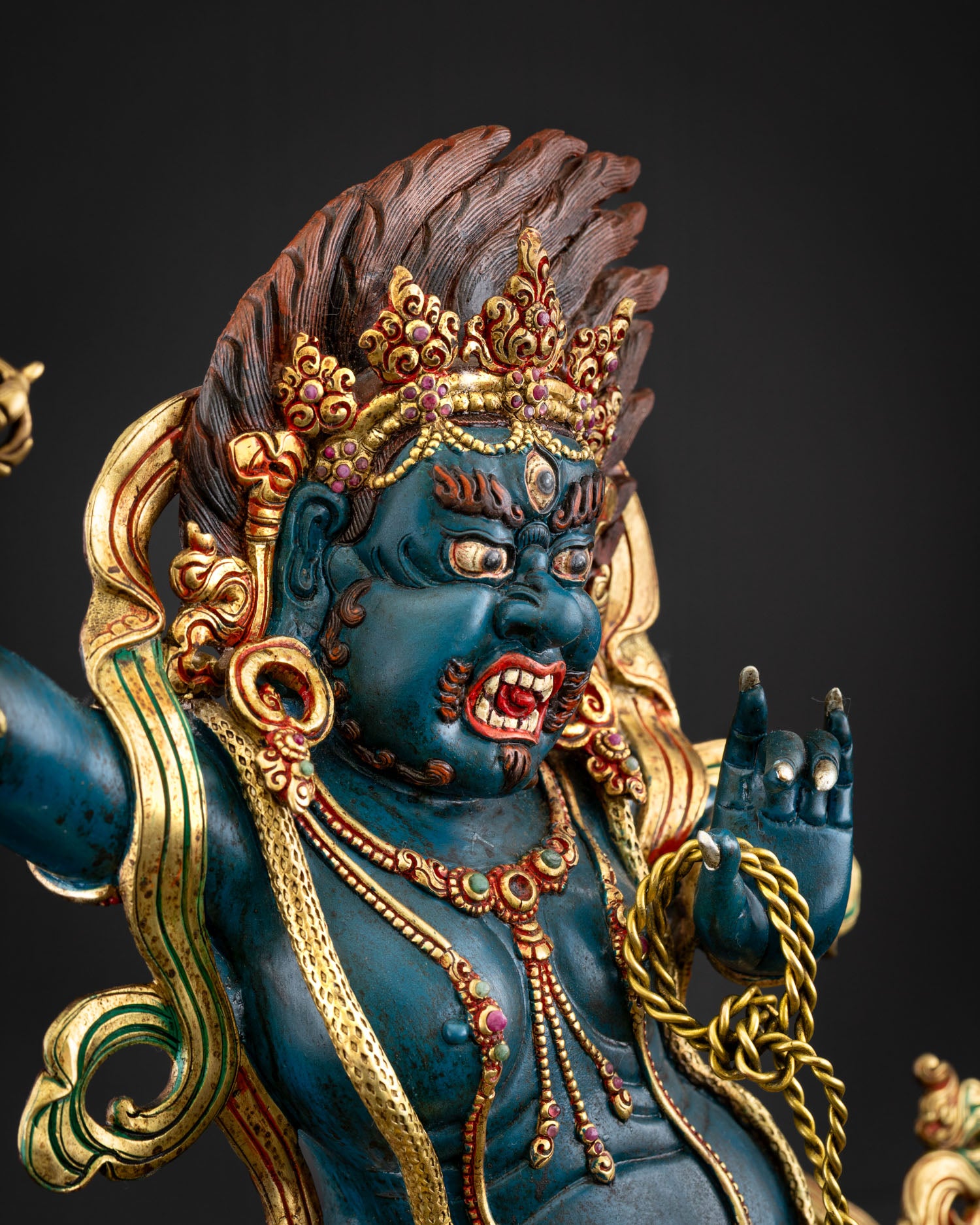 Vajrapani copper statue side detail gold ornaments tiger skin serpent coil lotus seat Nepal
