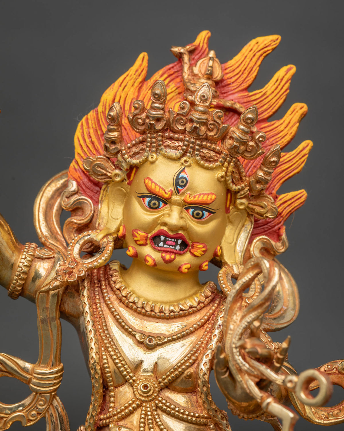 Vajrapani Statue close up 24K gold painted face vajra lasso Buddhist protector.