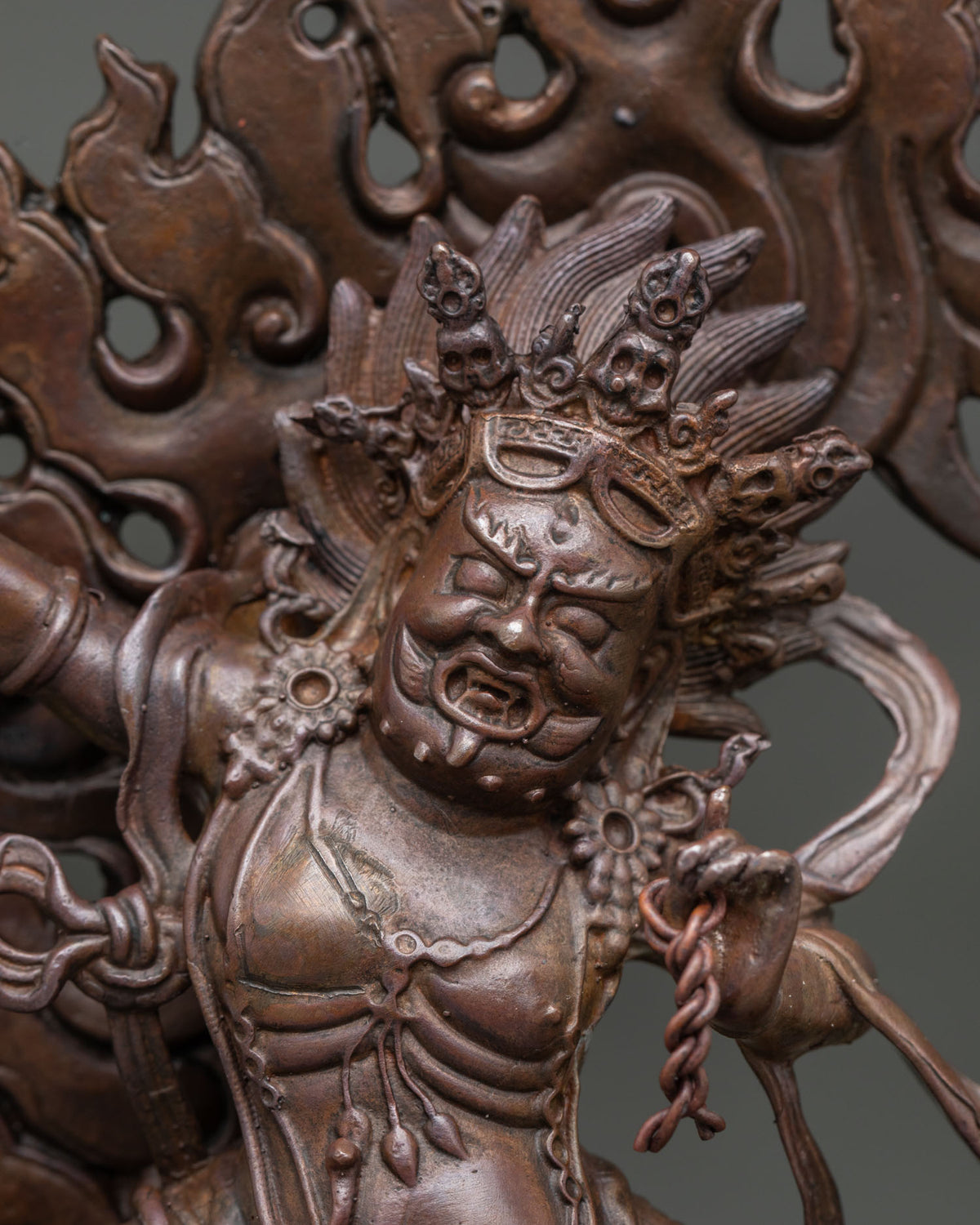 Vajrapani Statue close up featuring wrathful expression skull crown and tiger skin garment