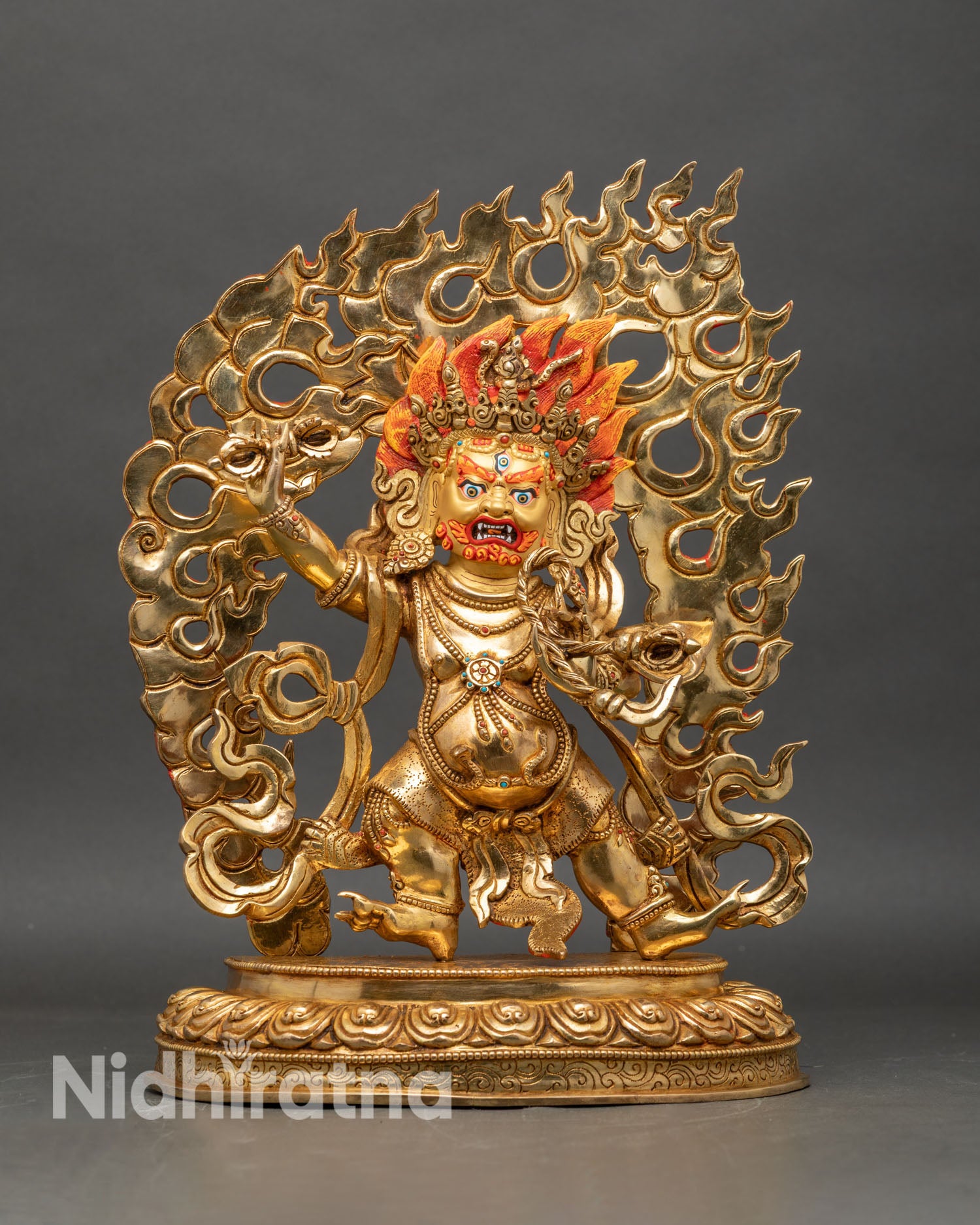 Vajrapani statue front view, wrathful thunderbolt holder with flaming halo and lotus base