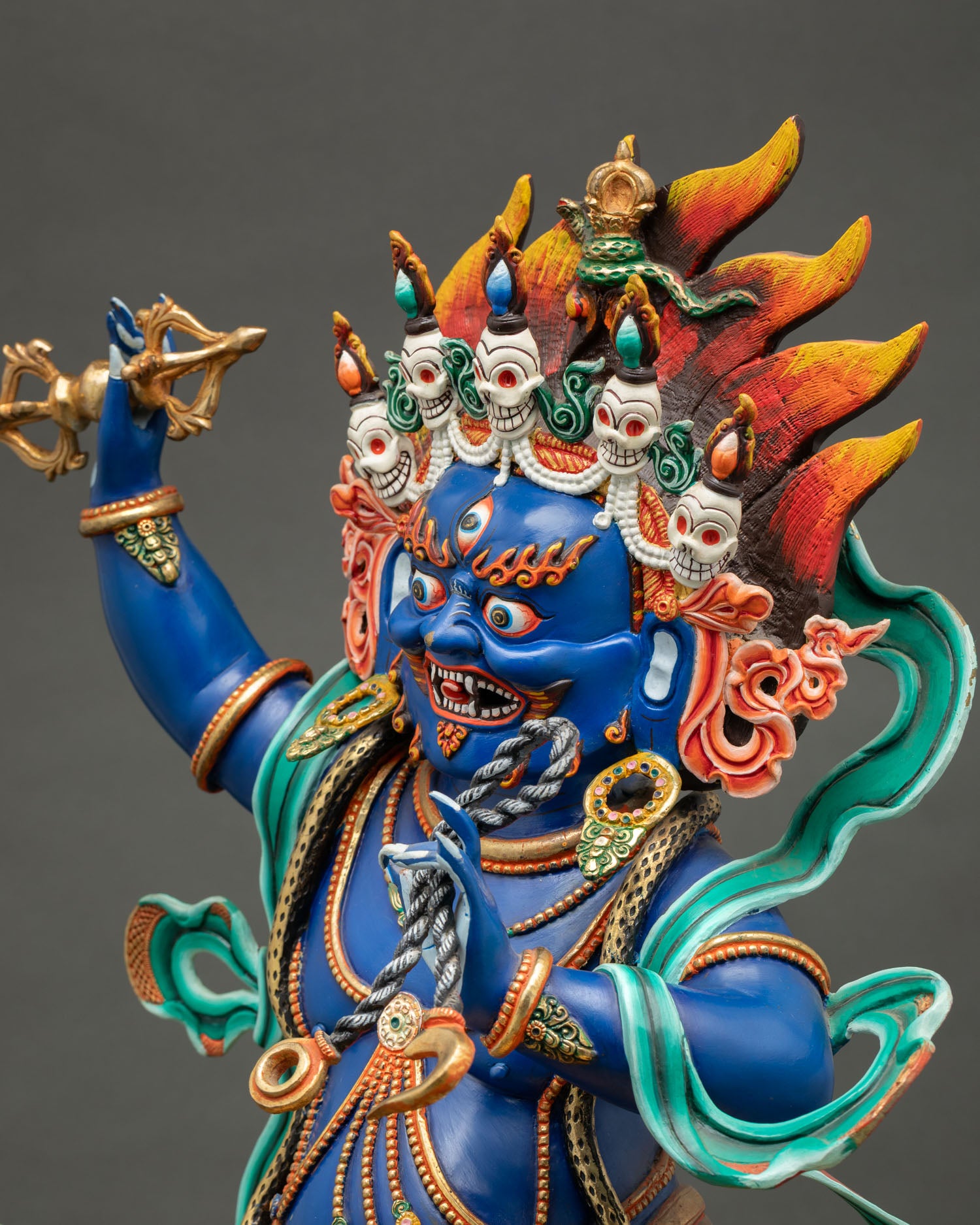 Vajrapani statue side view showing silk scarves, serpent ornaments, jewelry and wrathful stance detail