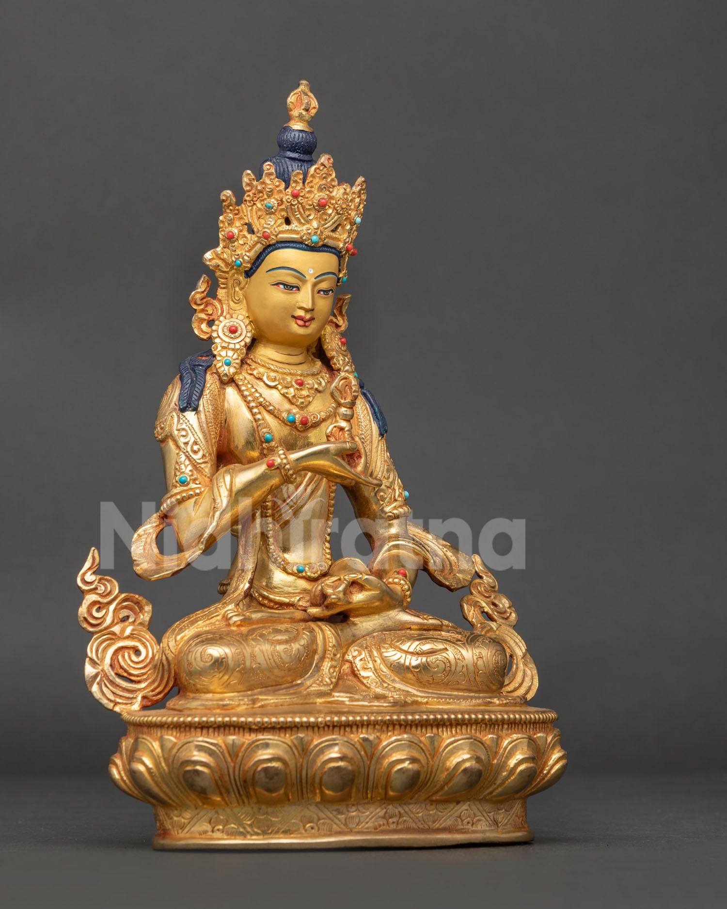 Vajrasattva buddhist statue with semi precious stones five jewel crown vajra and bell on lotus pedestal.