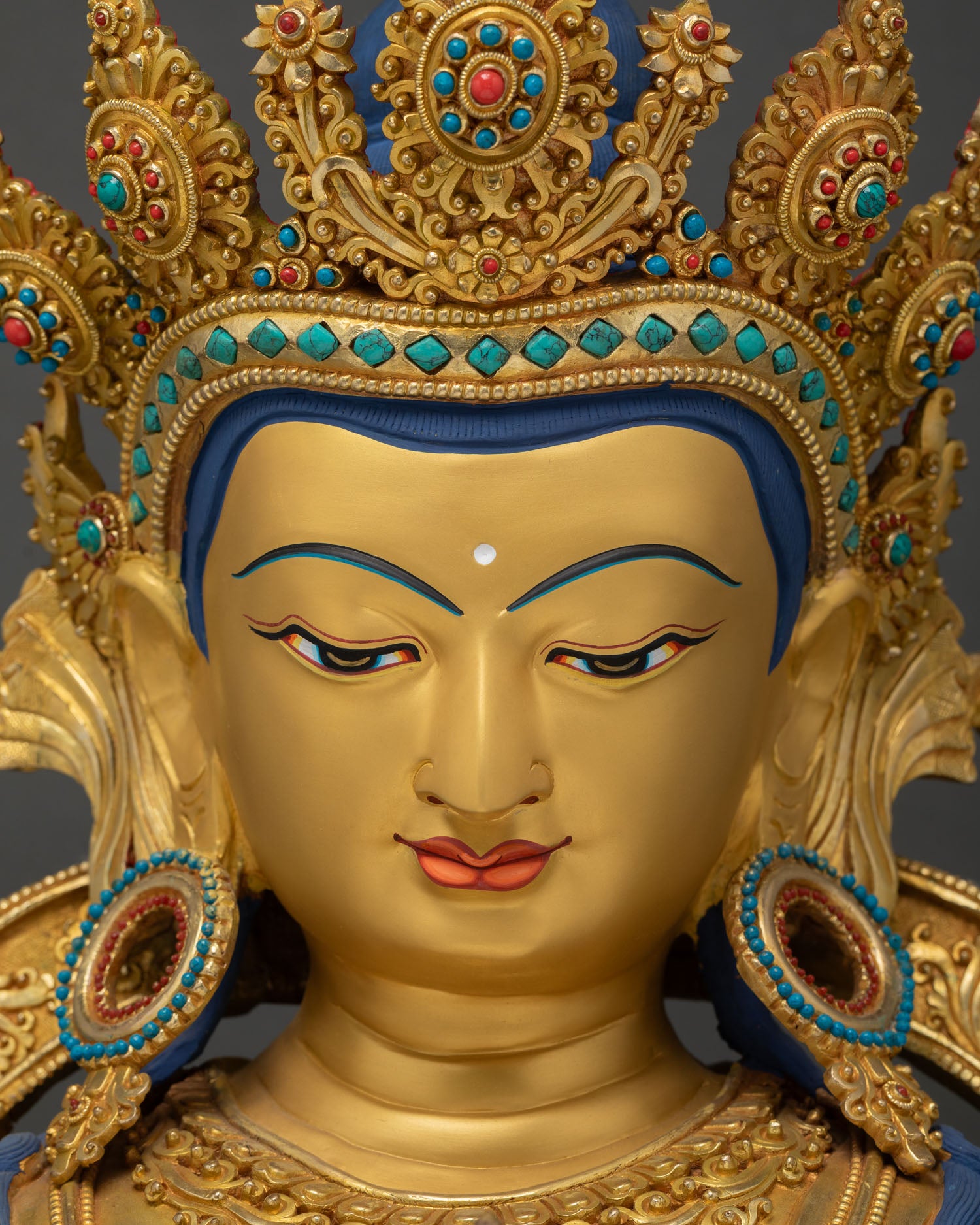 Vajrasattva face close-up gold mineral painted urna coral lips serene expression Newar art
