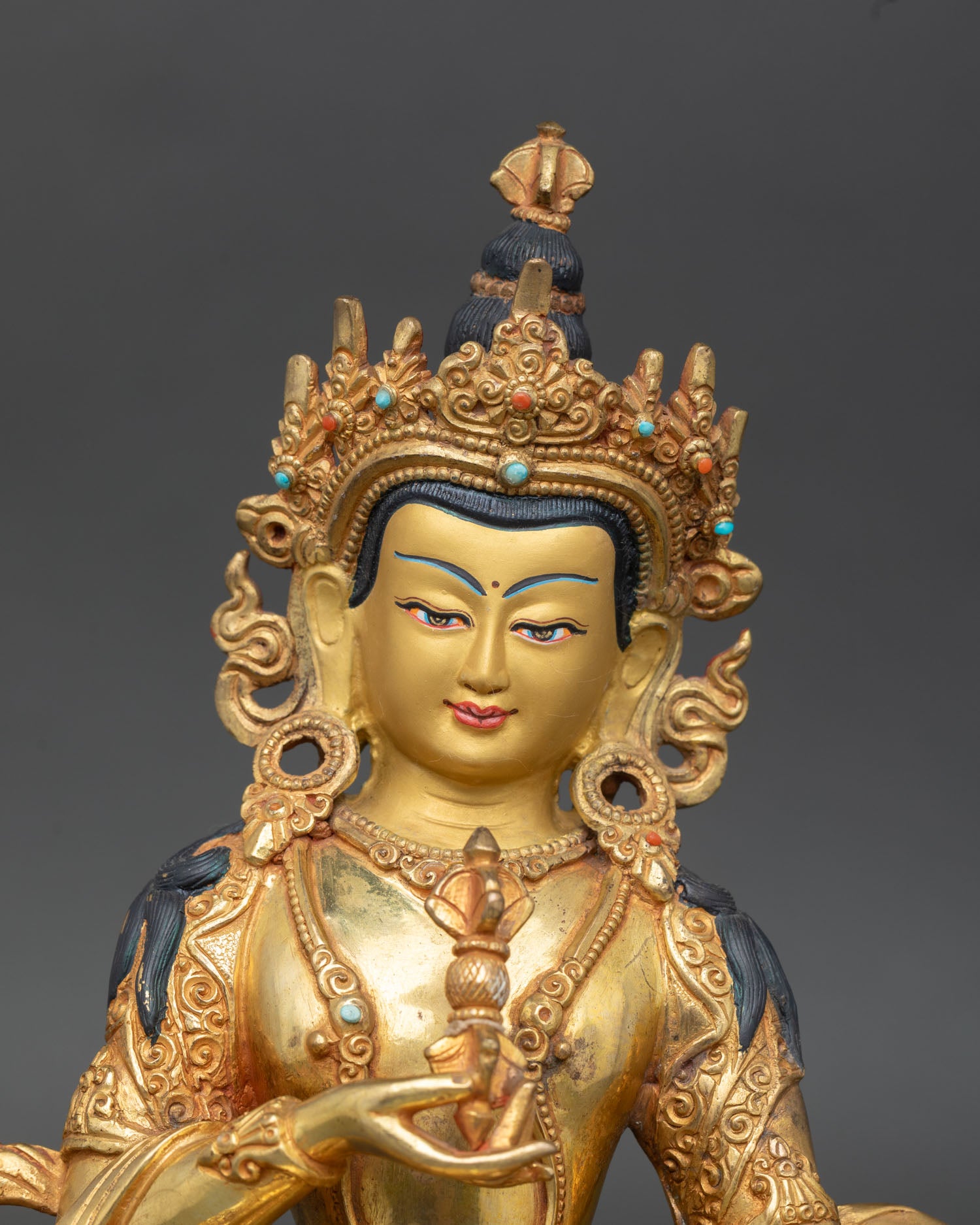 Vajrasattva face close up gold painted serene expression, detailed Himalayan craftsmanship