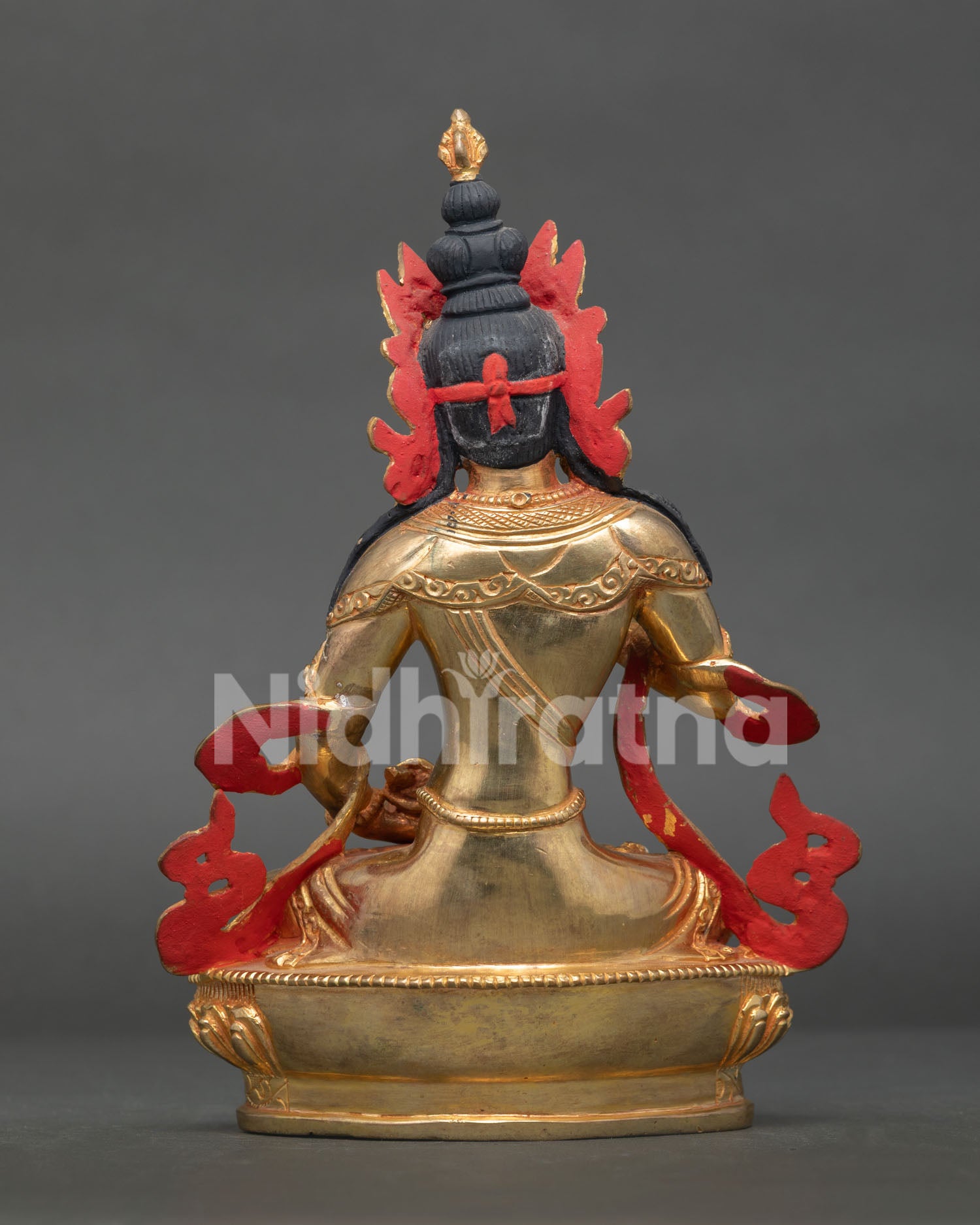 Vajrasattva statue displaying intricate gold gilded artwork and nepalese craftsmanship.
