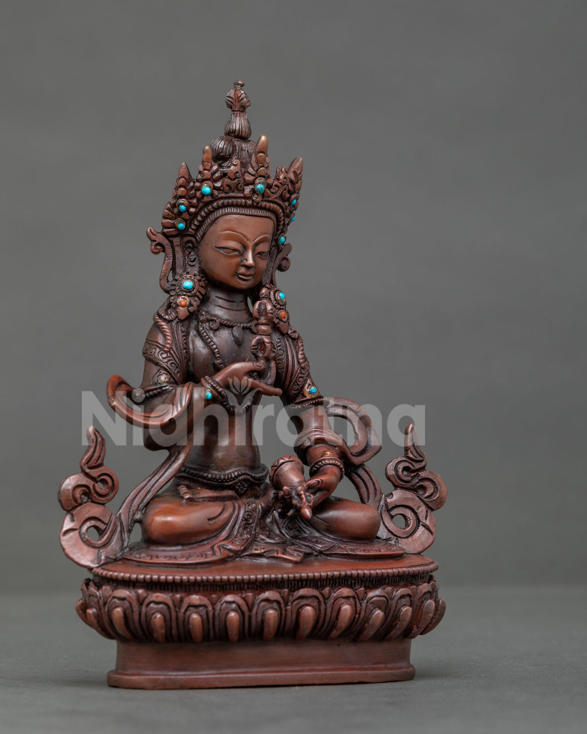 Vajrasattva statue from Patan Nepal holding vajra and bell with jeweled crown and ornaments.