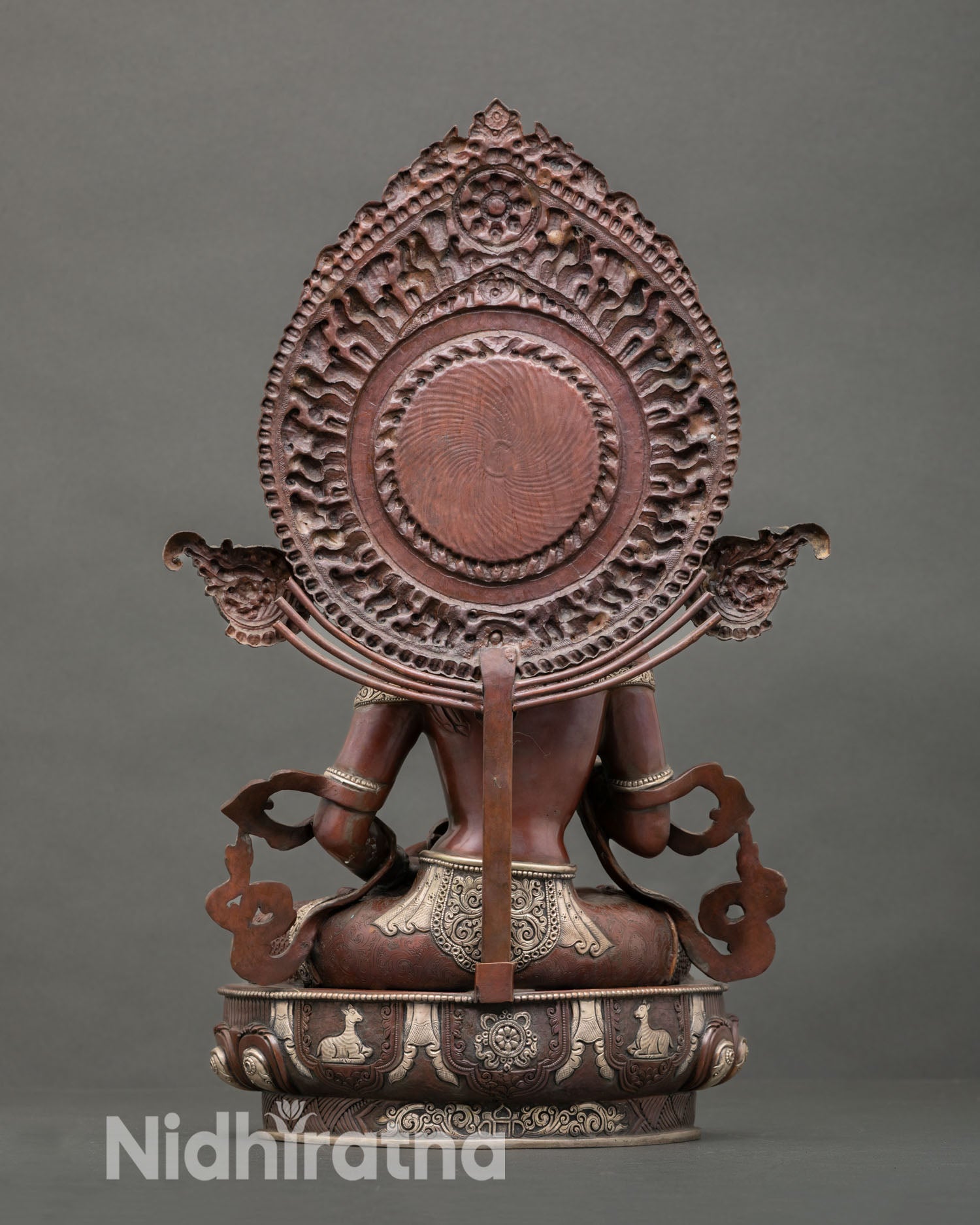Vajrasattva statue on fully bloomed lotus pedestal with radiant halo behind head representing purification of karma enlightenment and spiritual light for altar decor