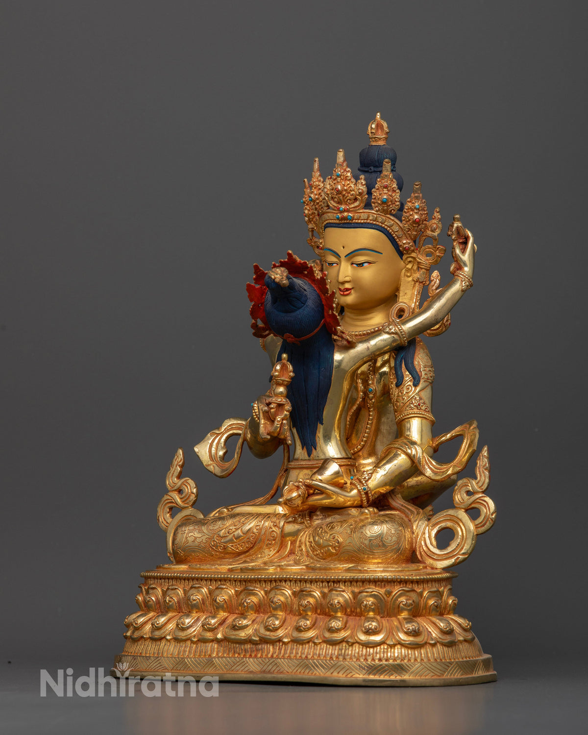 Vajrasattva Statue posture holding vajra and bell.