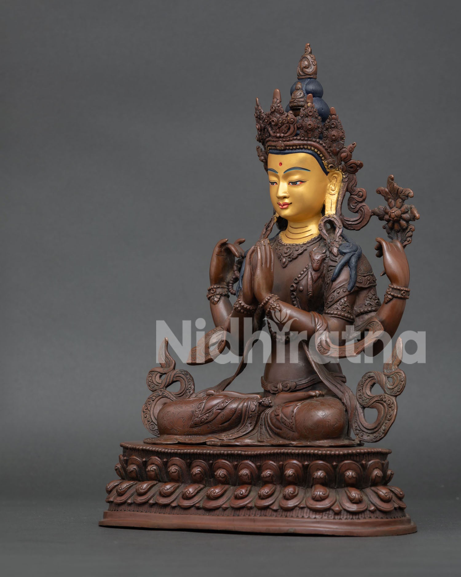 Vajrasattva statue seated on double lotus throne holding jewel, crystal mala, and white lotus flower.