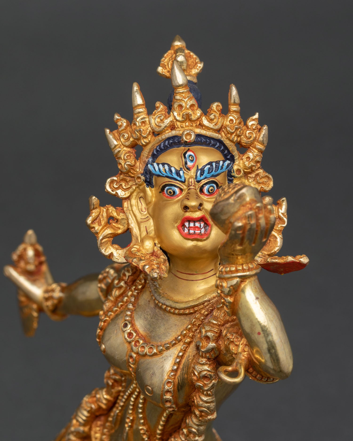 vajrayogini face close up fierce expression third eye gold painted wrathful dakini sculpture nepal