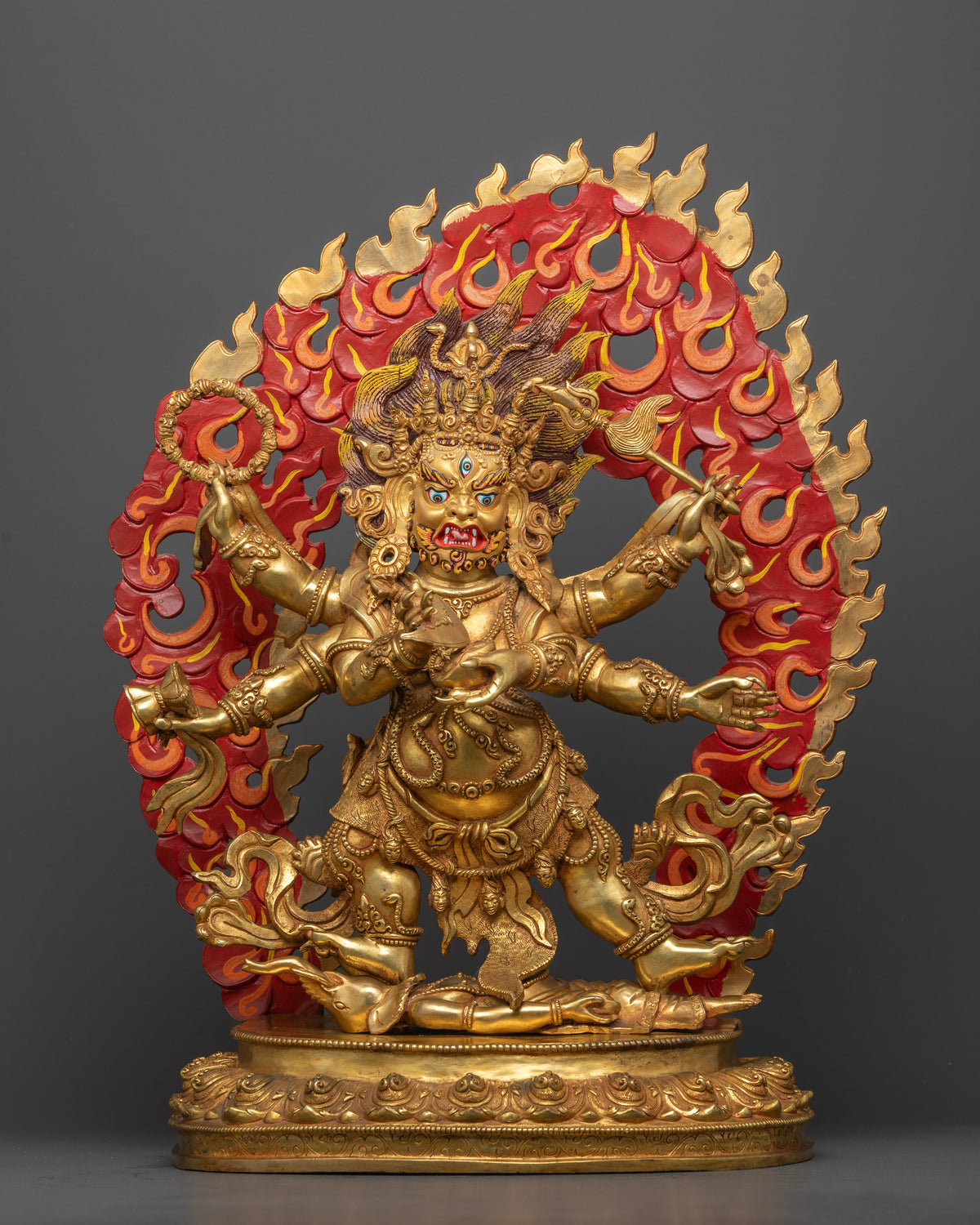 White Six Armed Mahakala Statue front view with six ritual implements and blazing wisdom halo.