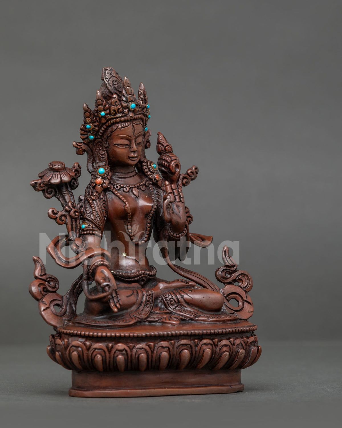 White tara buddhist statue seated on hand carved lotus pedestal with semi precious stones.