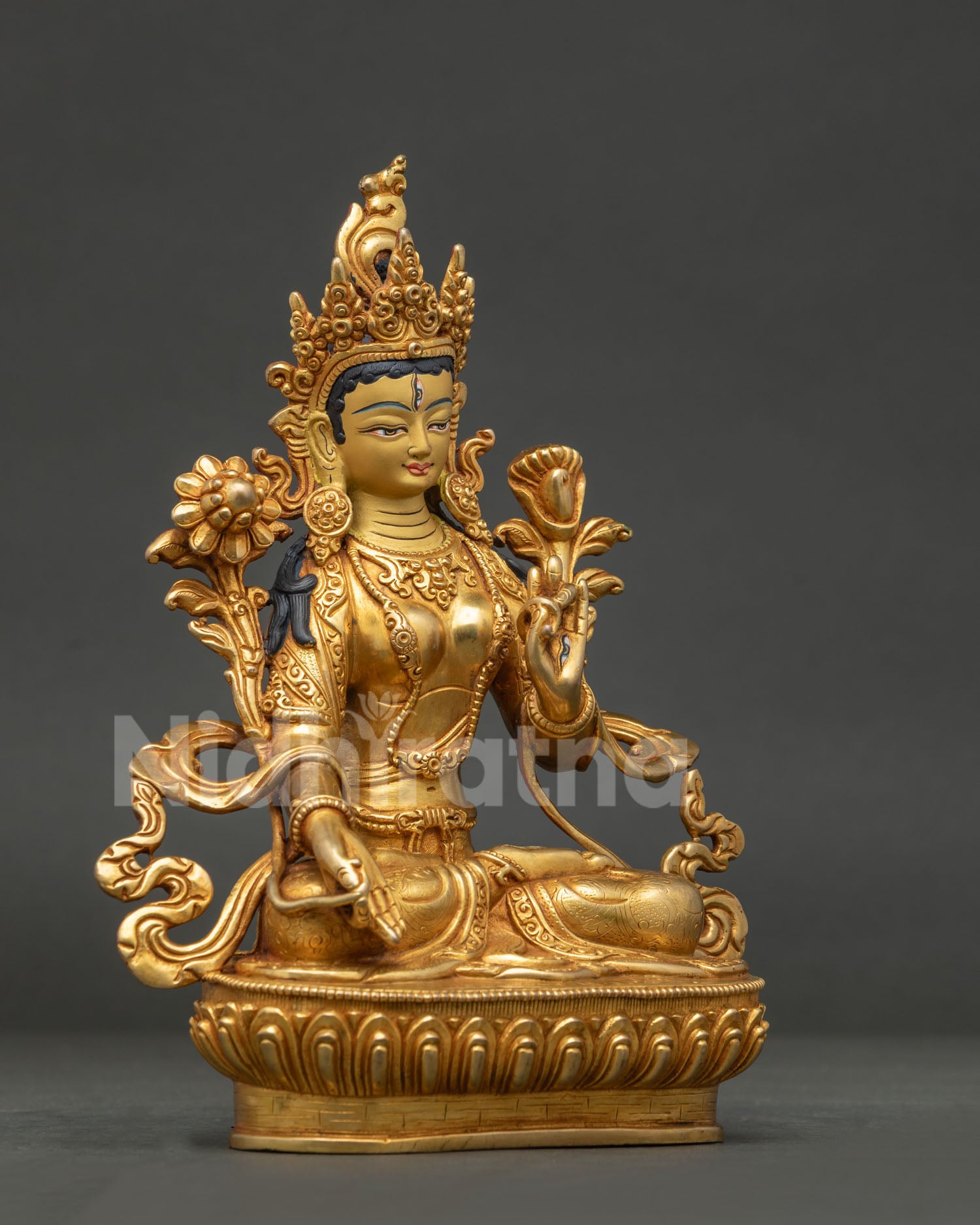 White Tara Buddhist statue with 24k gold painted face and lotus pedestal.