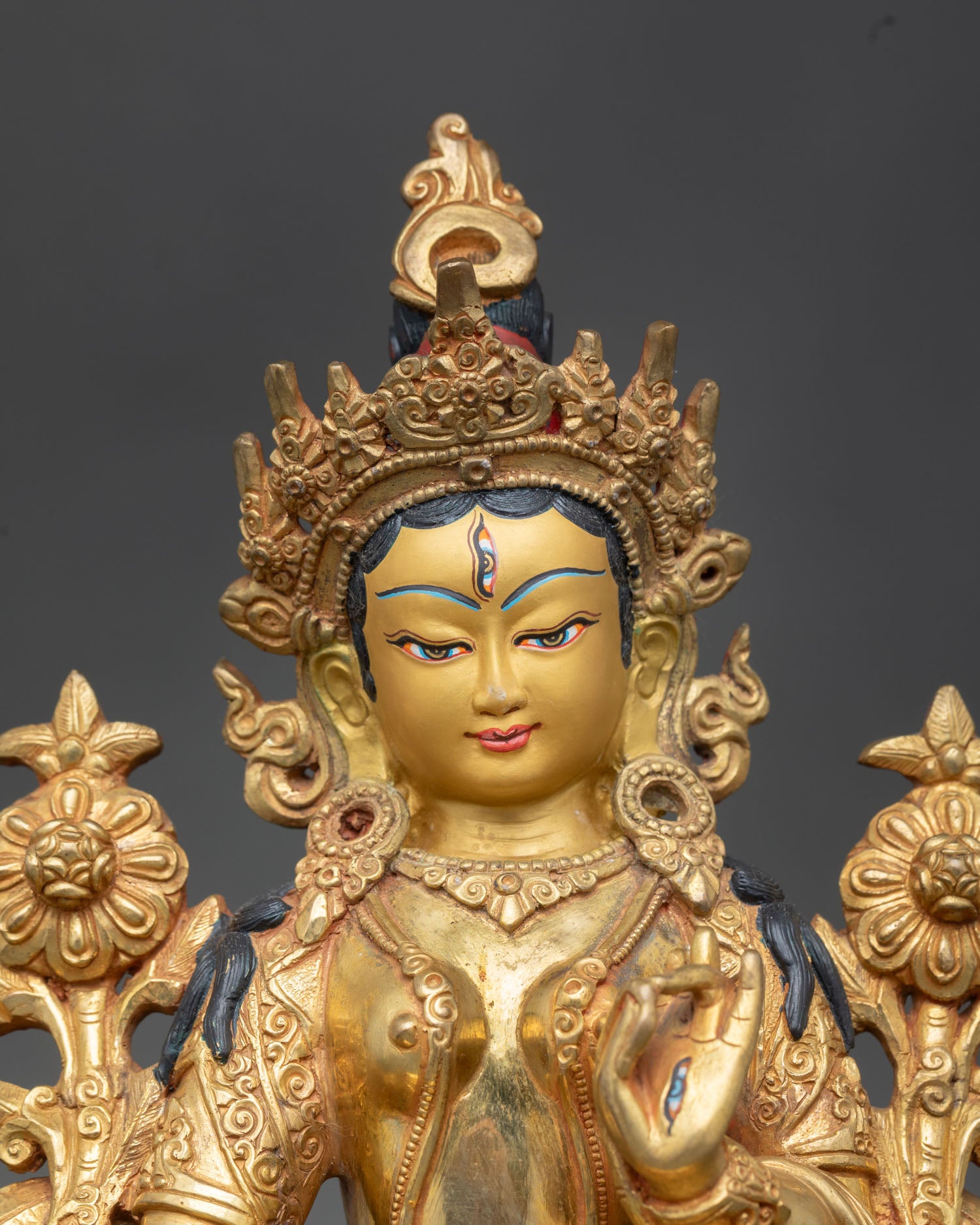 White Tara close up gold painted face seven eyes detail lotus stem sacred Buddhist sculpture Patan Nepal