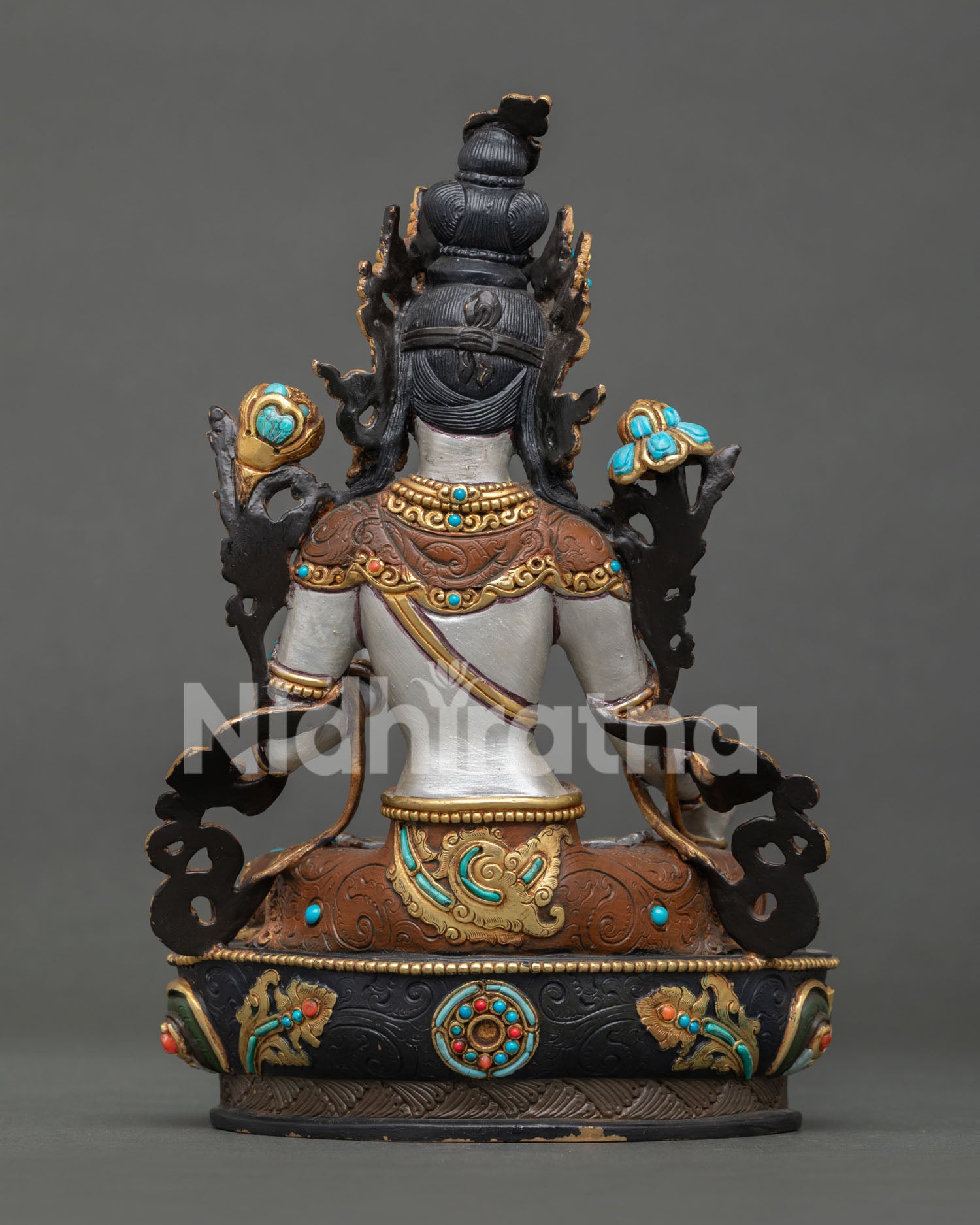 White Tara sculpture with lotus flowers beside shoulders representing wisdom and enlightenment