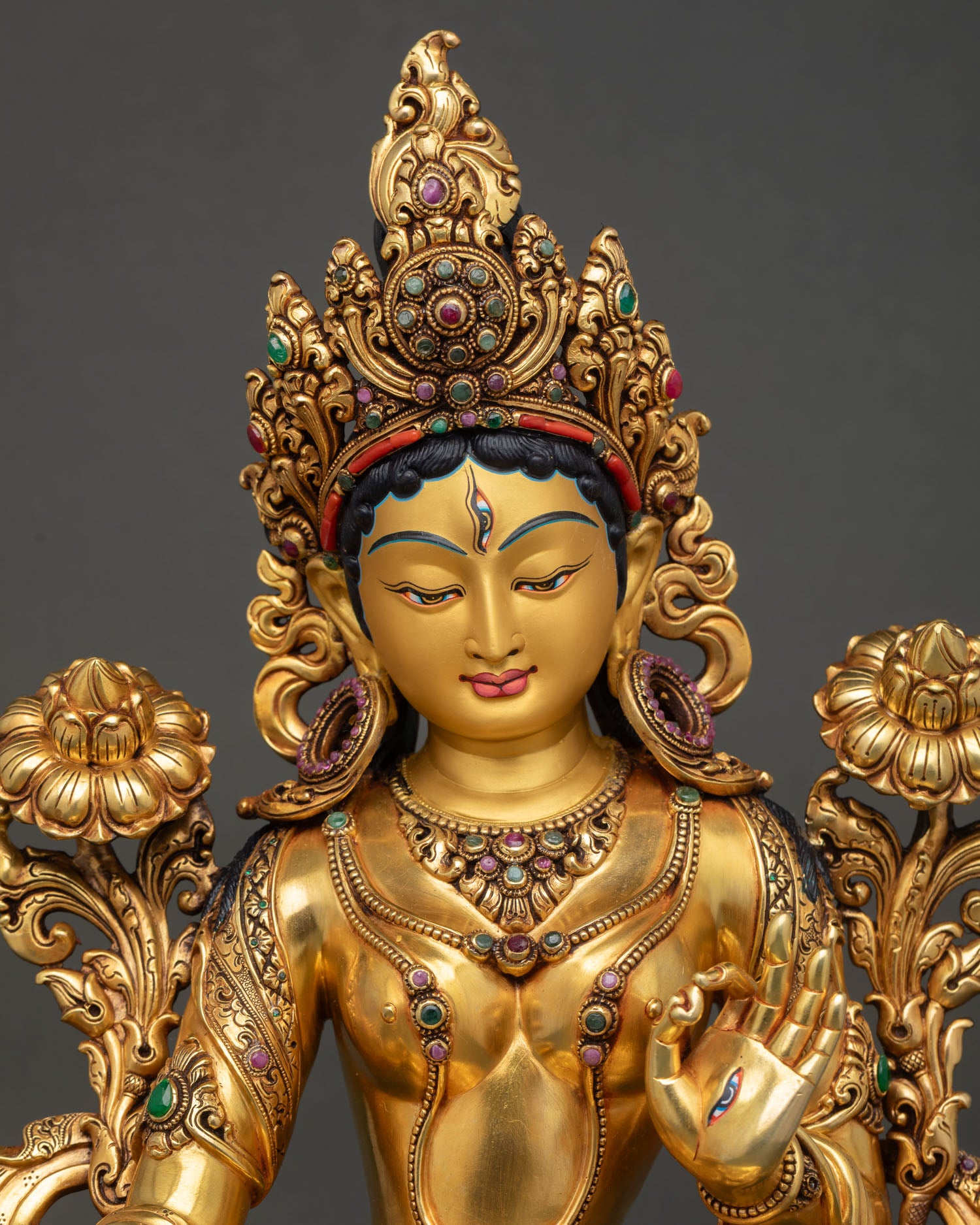 white tara statue close up view intricate gold gilding repousse detailing sacred nepalese art