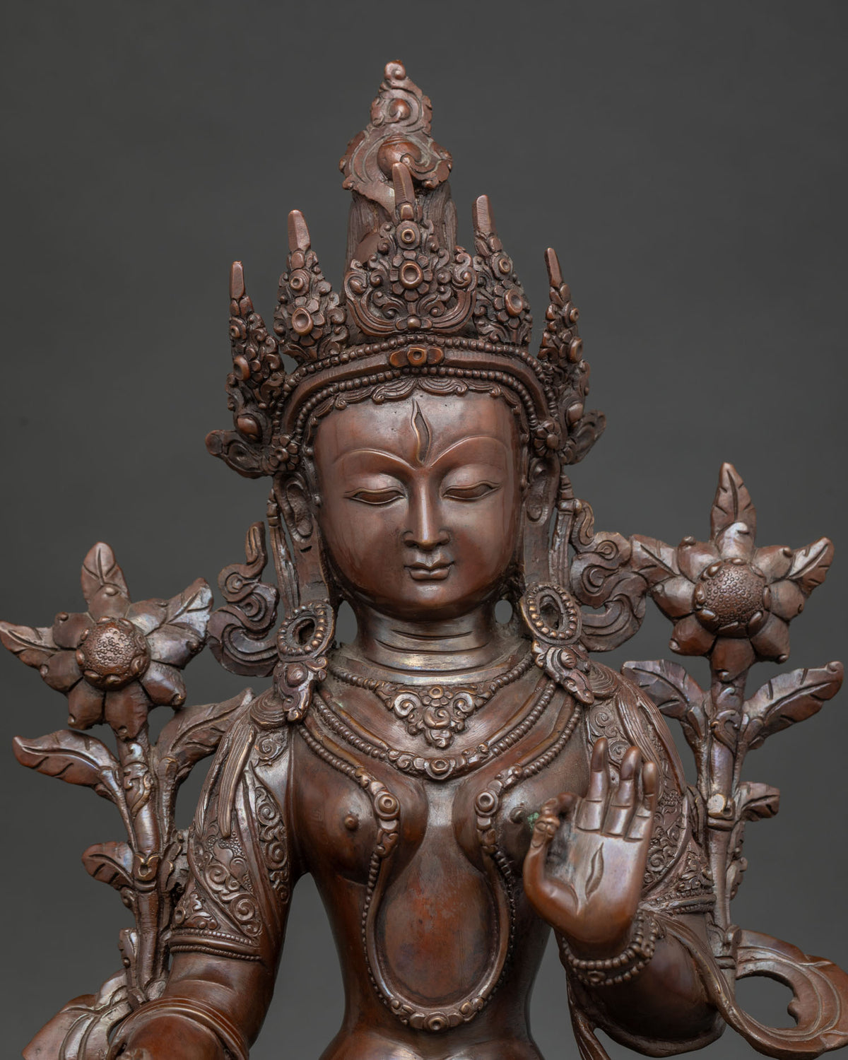 white tara statue close up view lotus pedestal detail oxidized copper nepal