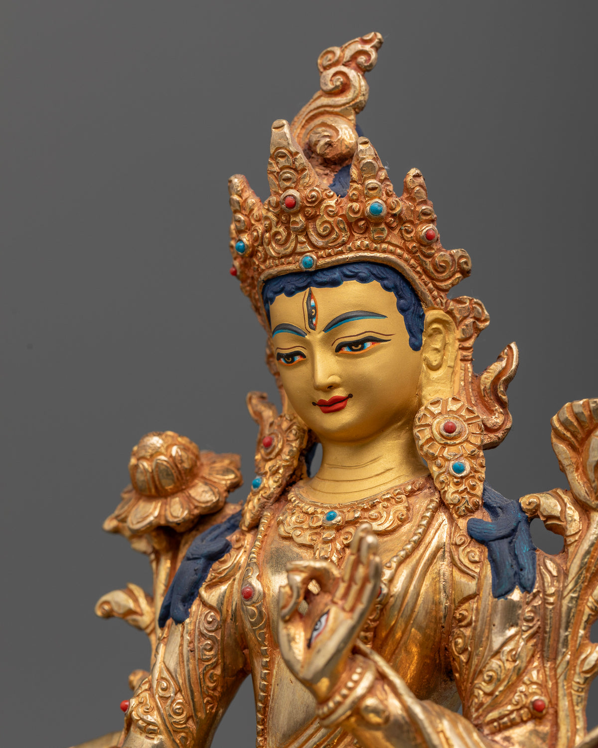 White Tara statue detail showing seven eyes and serene expression.