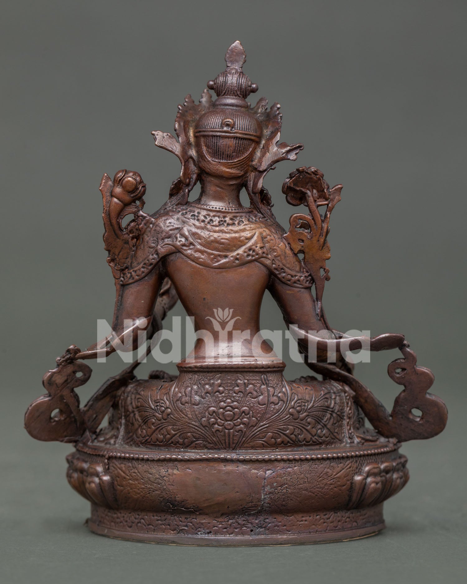 White tara statue displaying detailed copper artwork and himalayan buddhist design.
