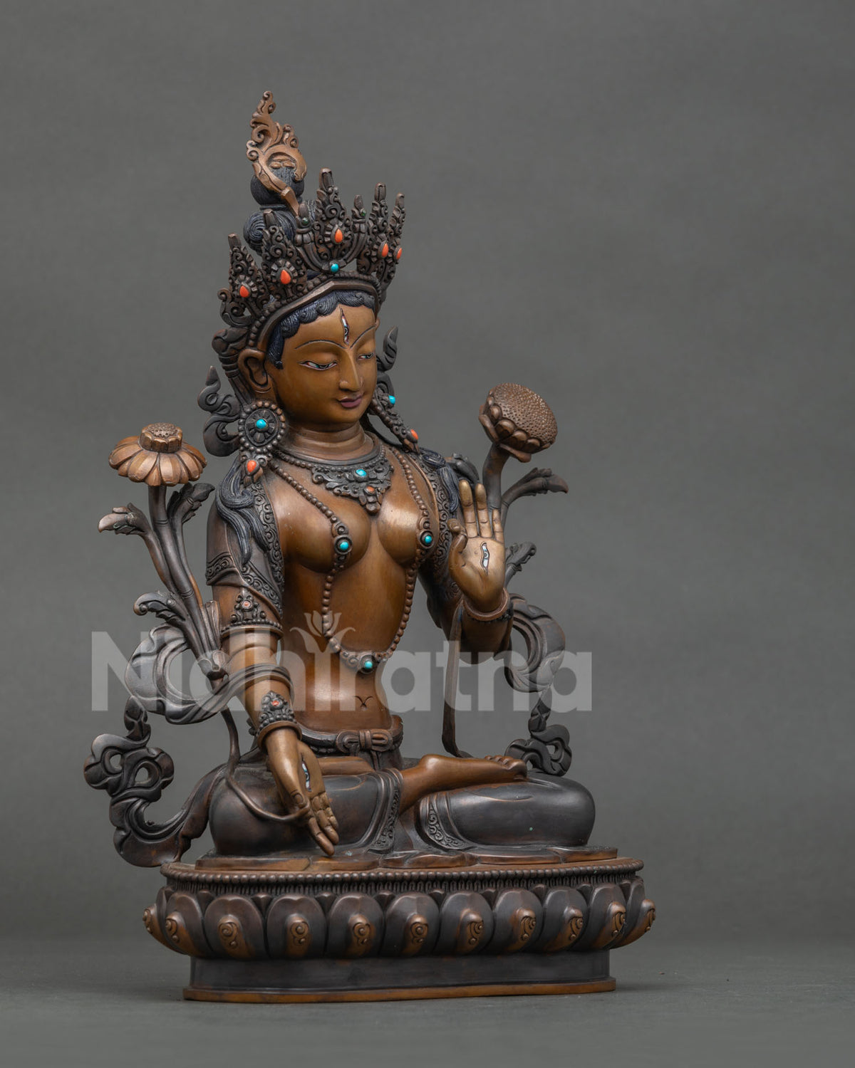 White Tara Statue from Nepal seated on lotus pedestal with seven eyes.