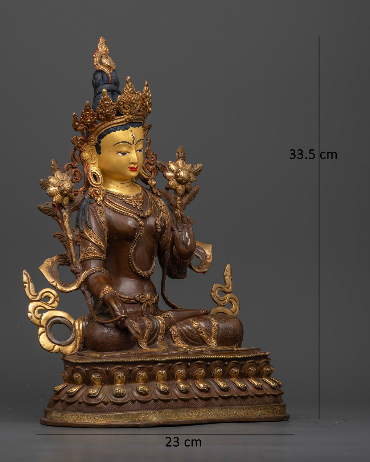 White Tara statue featuring a 24K gold painted face and delicate lotus flowers rising beside her shoulders.